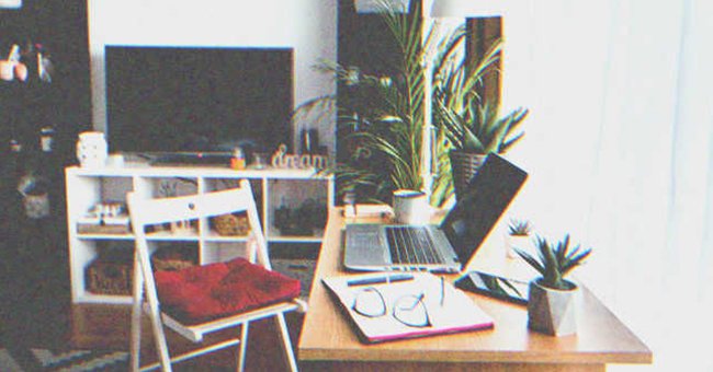 A work desk with a laptop open. | Source: Shutterstock