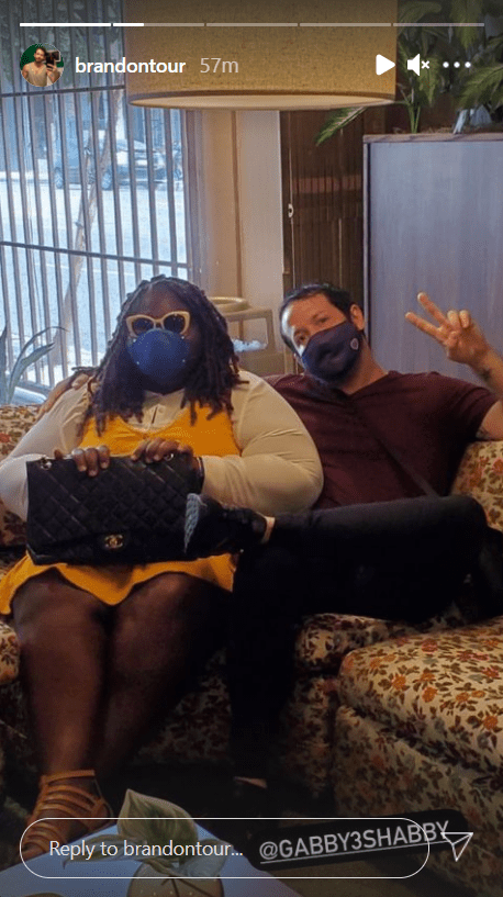 Gabby Sidibe andBrandon Frankel sitting on a couch with facemasks on. | Photo: instagram.com/brandontour