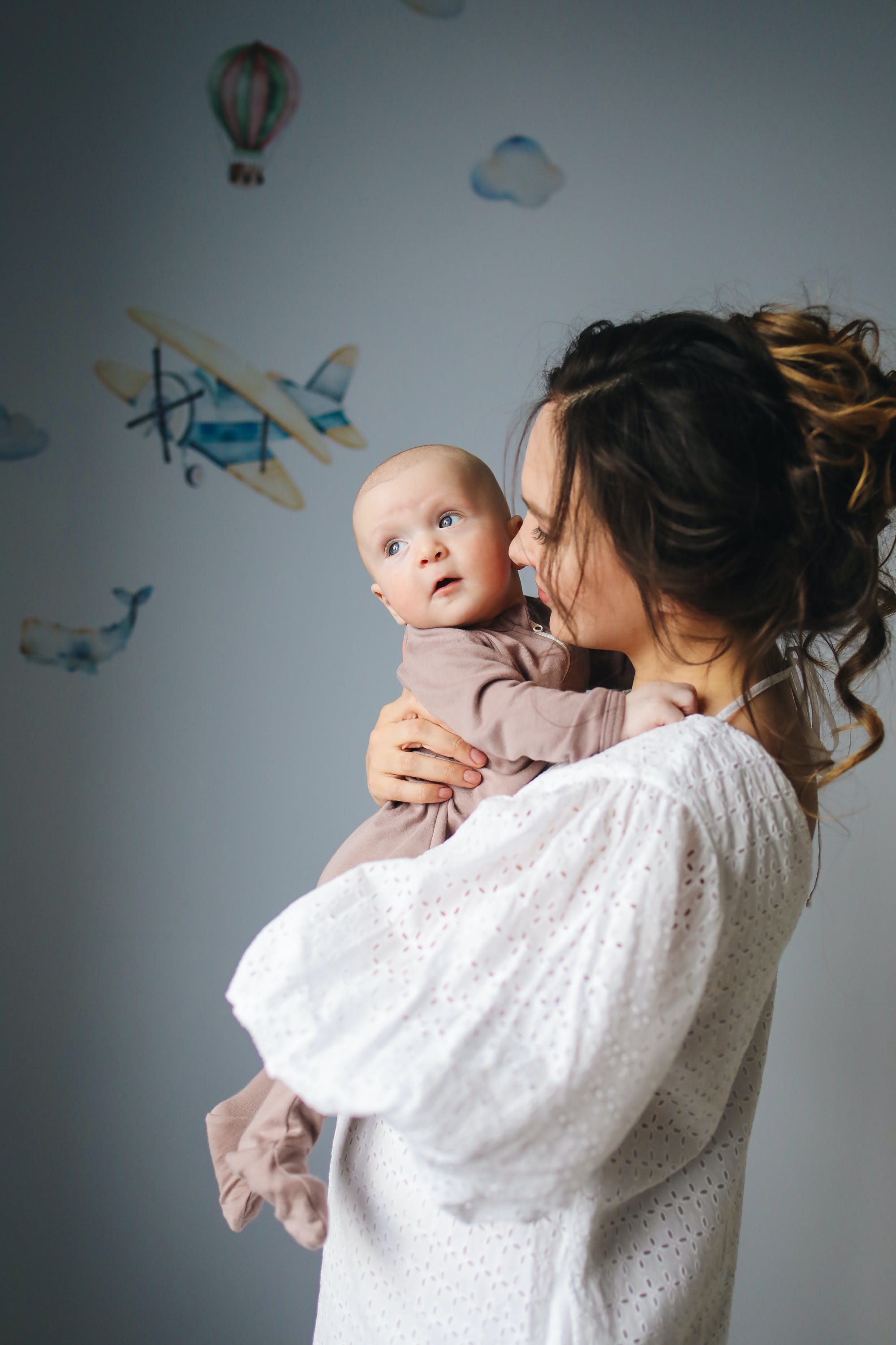 A mother holding a baby | Source: Pexels