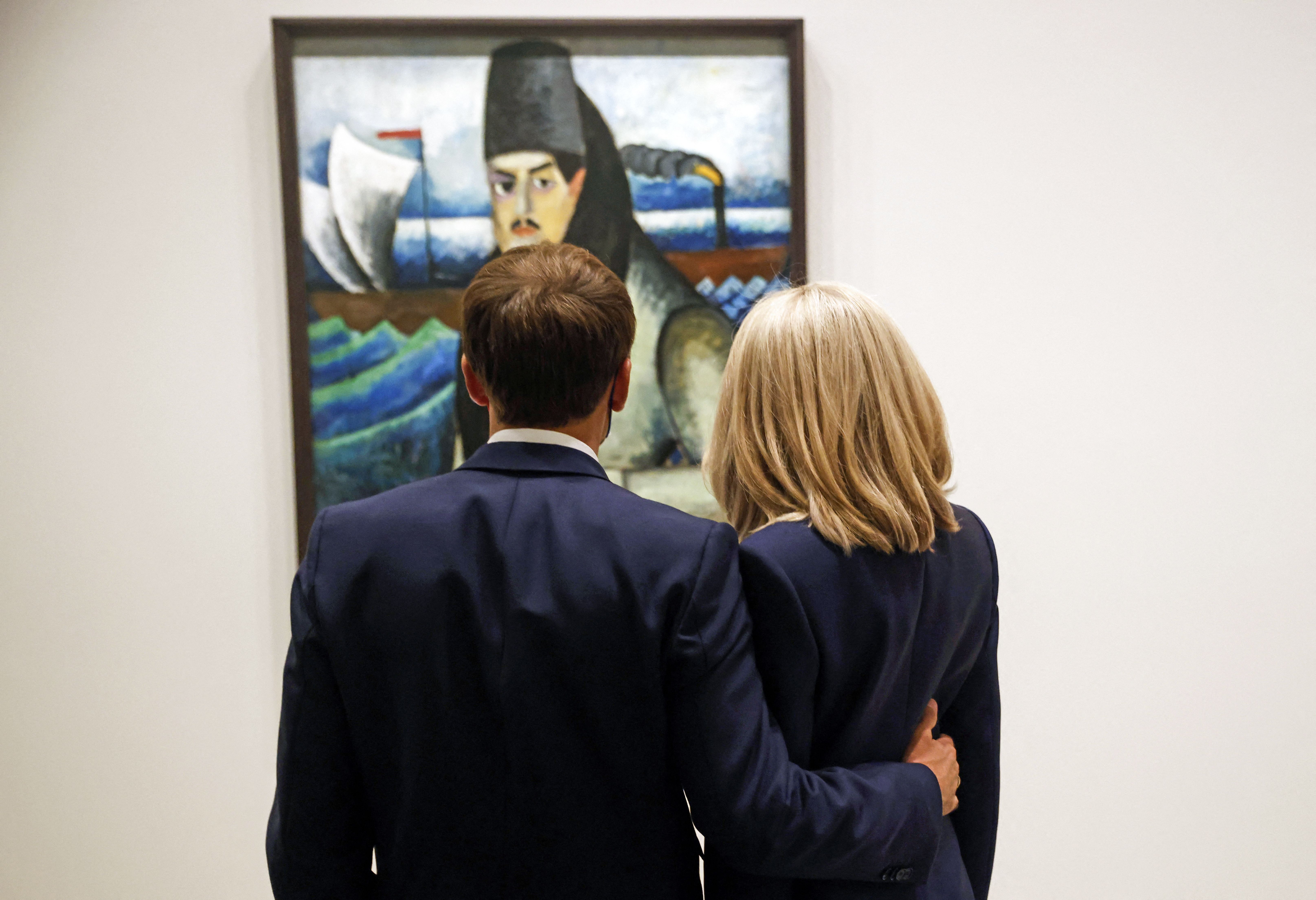 The Macrons stood side by side, admiring a painting at the opening of “The Morozov Collection, Icons of Modern Art” exhibition at the Fondation Louis Vuitton in Paris on September 21, 2021.