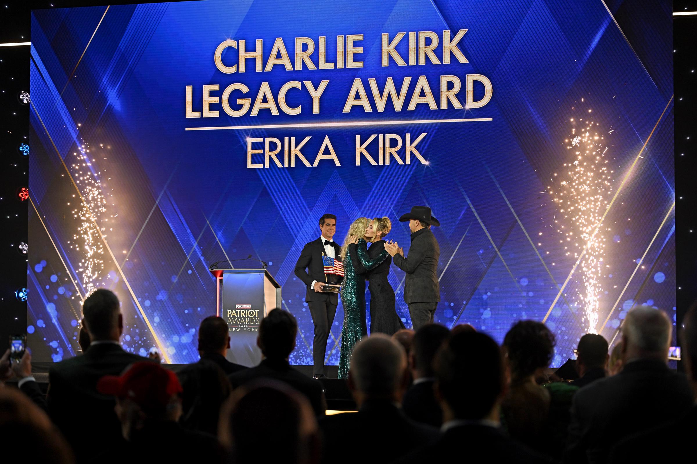 Jesse Watters, Brittany Aldean and Jason Aldean present the inagural Charlie Kirk Legacy Award to Erika Kirk onstage during the 2025 Fox Nation Patriot Awards | Source: Getty Images