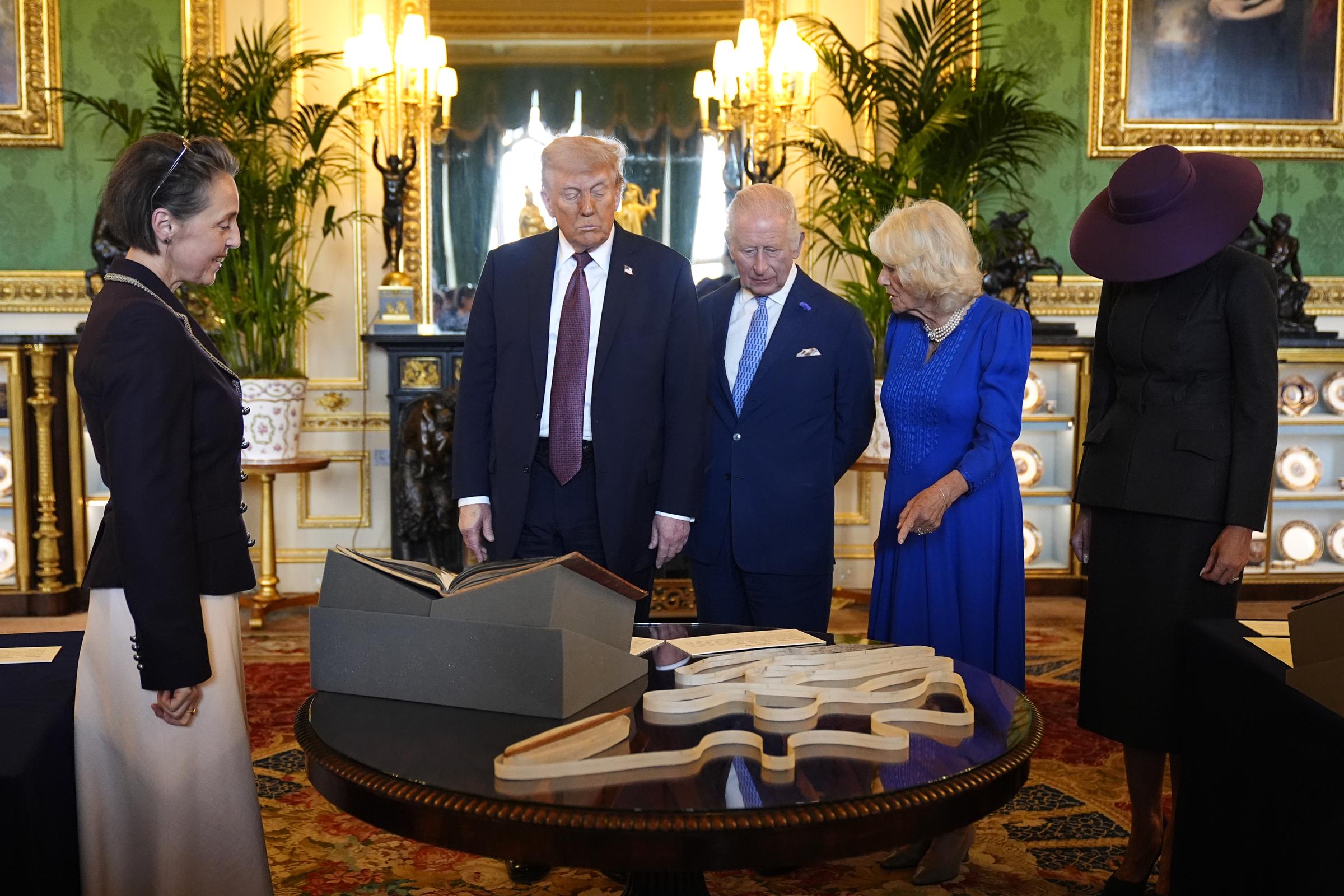 US President Donald Trump, King Charles III, Queen Camilla and First Lady Melania view items on display during a visit to the Royal Collection exhibition, in the Green Drawing Room at Windsor Castle in England on September 17, 2025 | Source: Getty Images