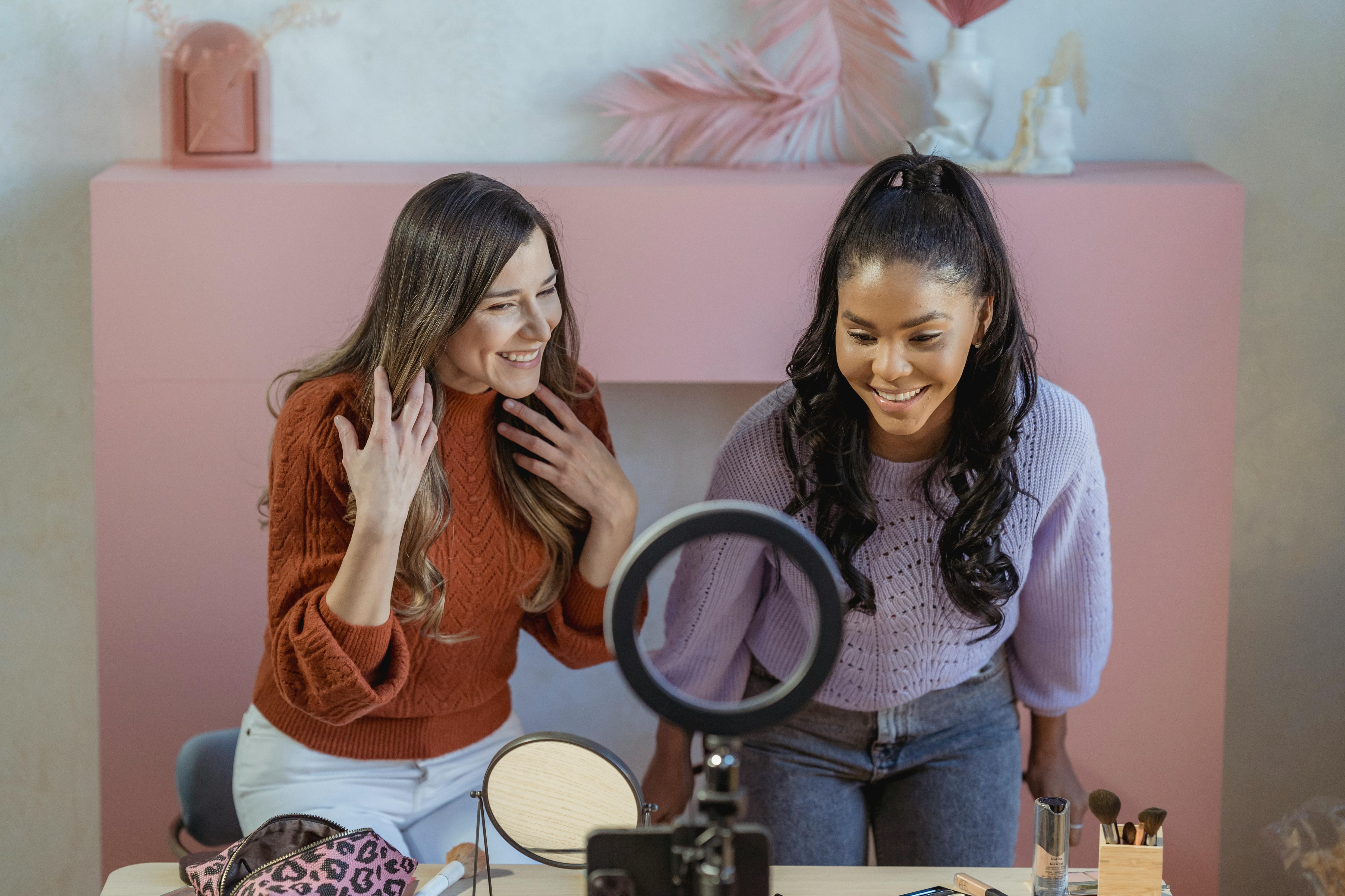 For illustration purposes only. Two woman look at the makeup and tools on the table | Source: Pexels