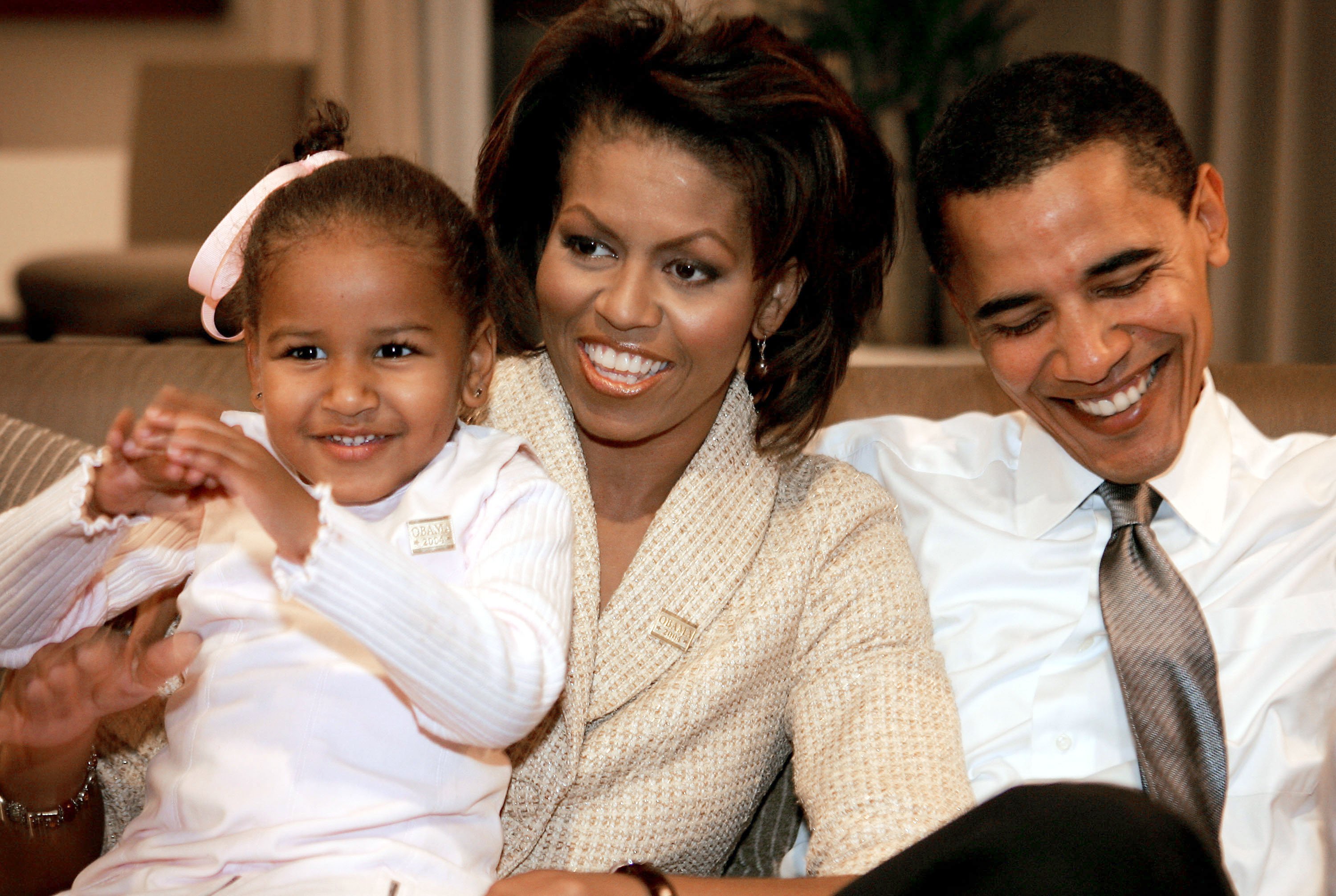Candidate for the U.S. Senate Barack Obama (D-IL) sits with his wife Michelle and daughters Sasha (L) in a hotel room as they wait for election returns to come in November 2, 2004, in Chicago, Illinois. | Source: Getty Images.