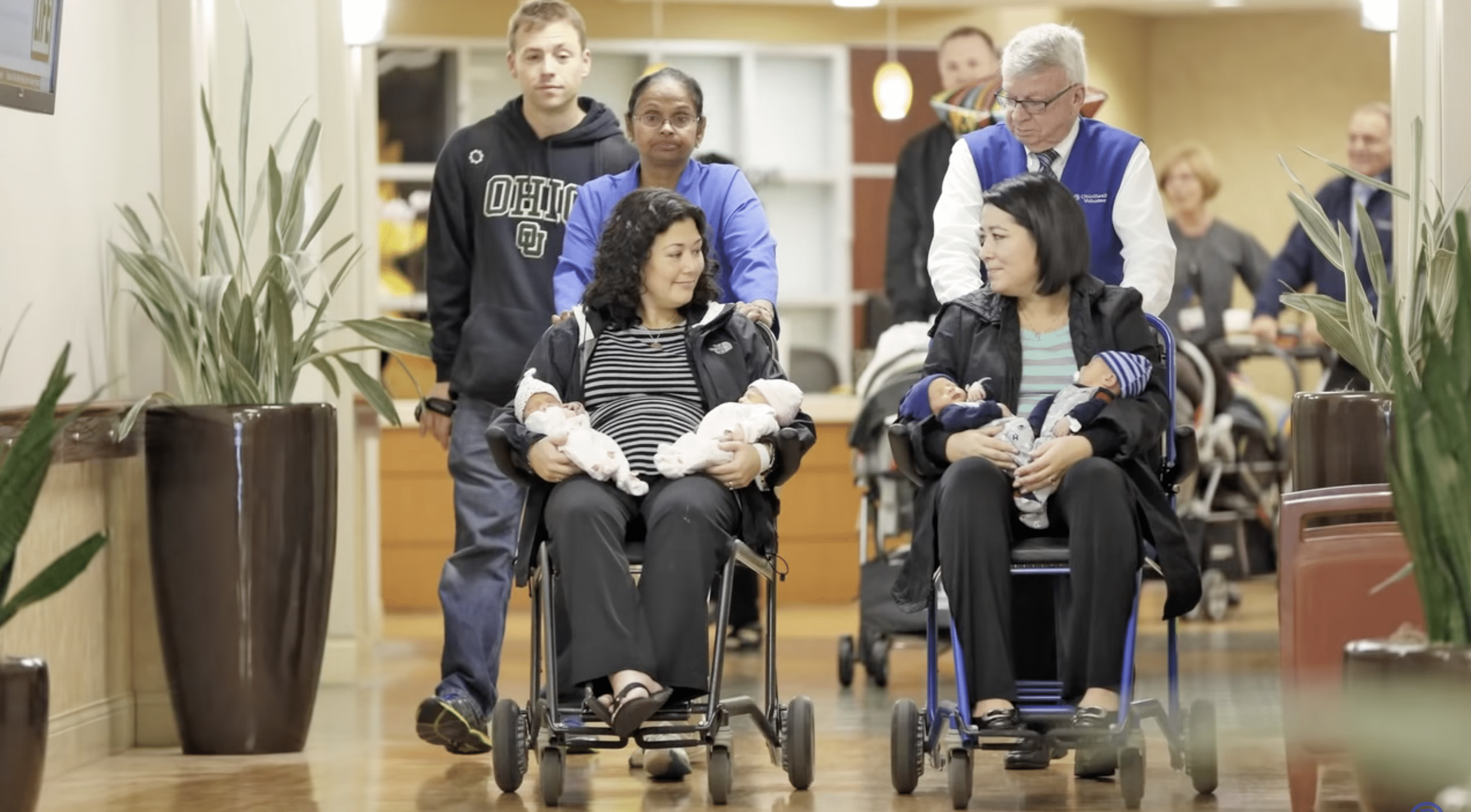Annie Johnston and Chrissy Knott carrying the quadruplets. | Photo: YouTube.com/TheColumbusDispatch