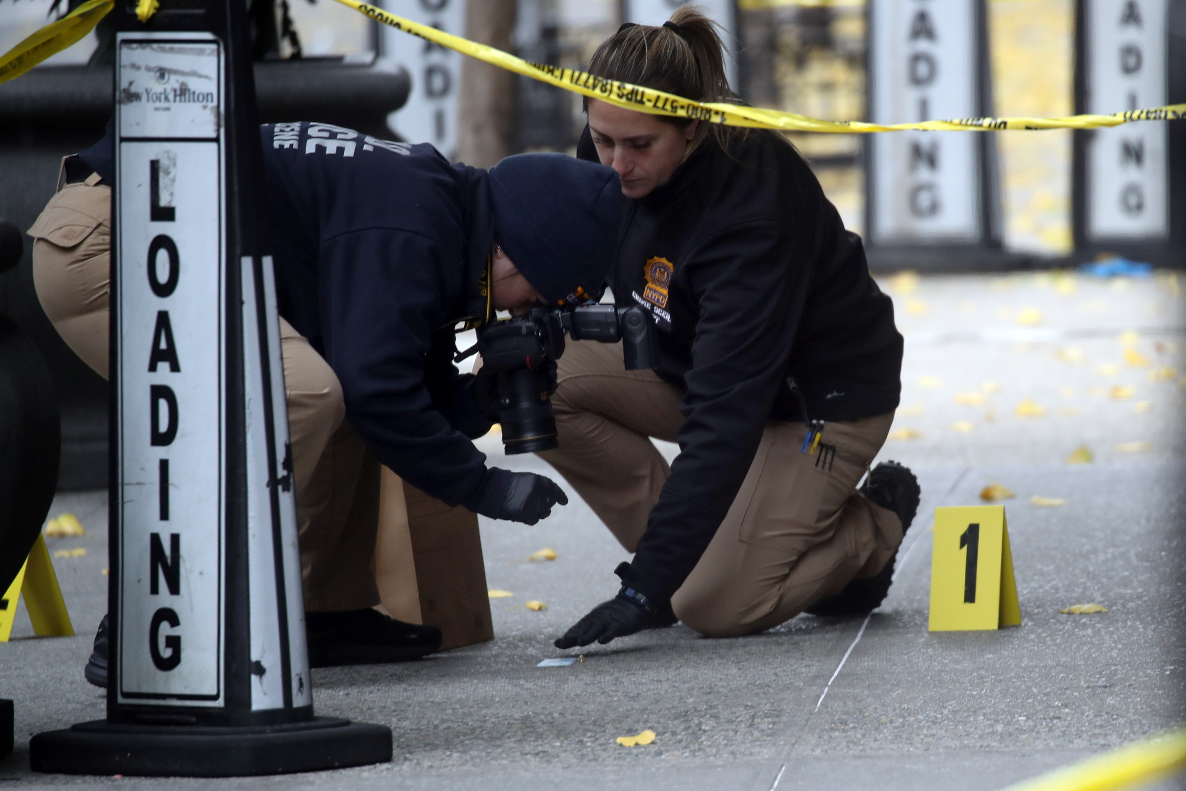 Police mark bullet casings outside the Hilton Hotel in Midtown Manhattan where Brian Thompson was shot on December 4, 2024 | Source: Getty Images