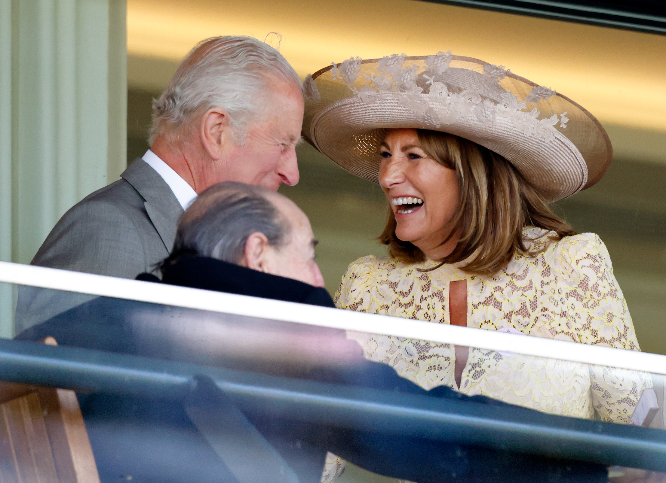 Carole Middleton shares a laugh with King Charles III as they enjoy a cheerful exchange in the royal box, capturing one of the day's most lighthearted moments at Royal Ascot.