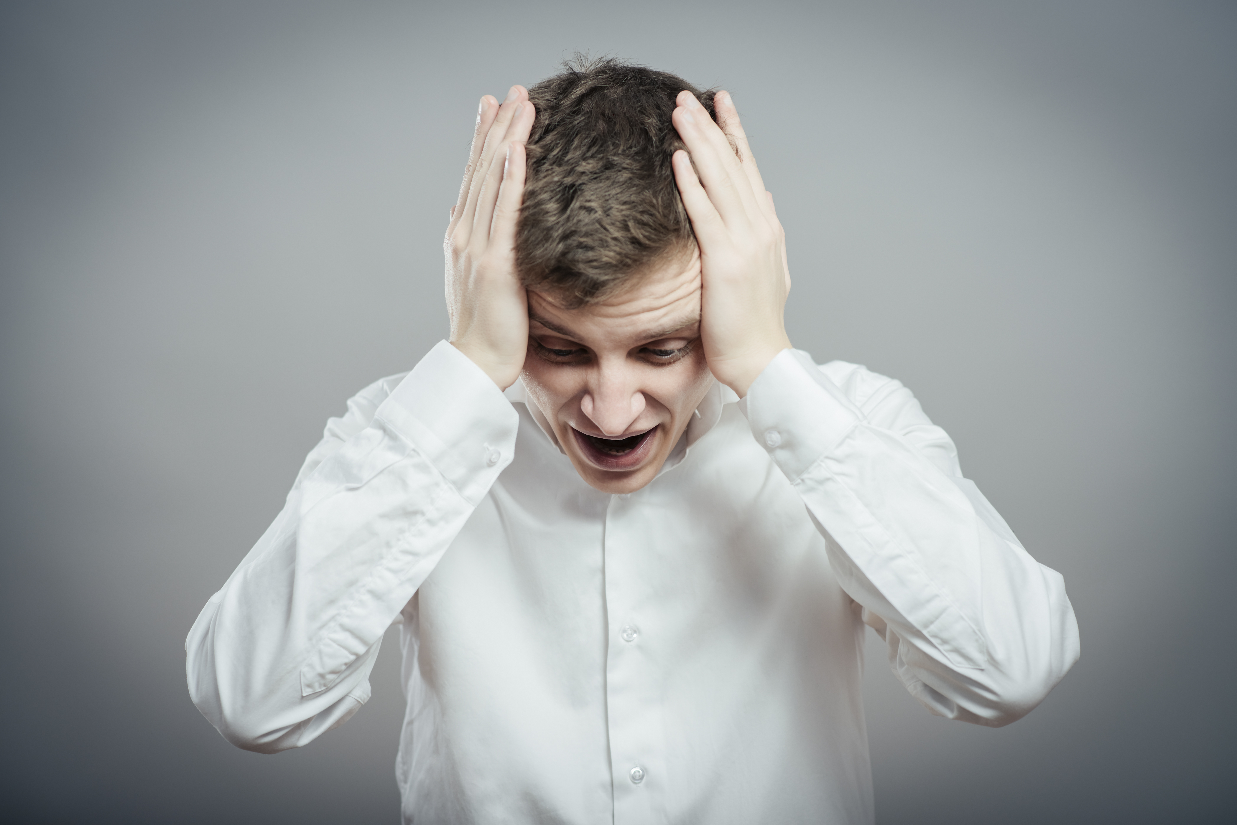 Frustrated man with his hands on his head | Source: Shutterstock