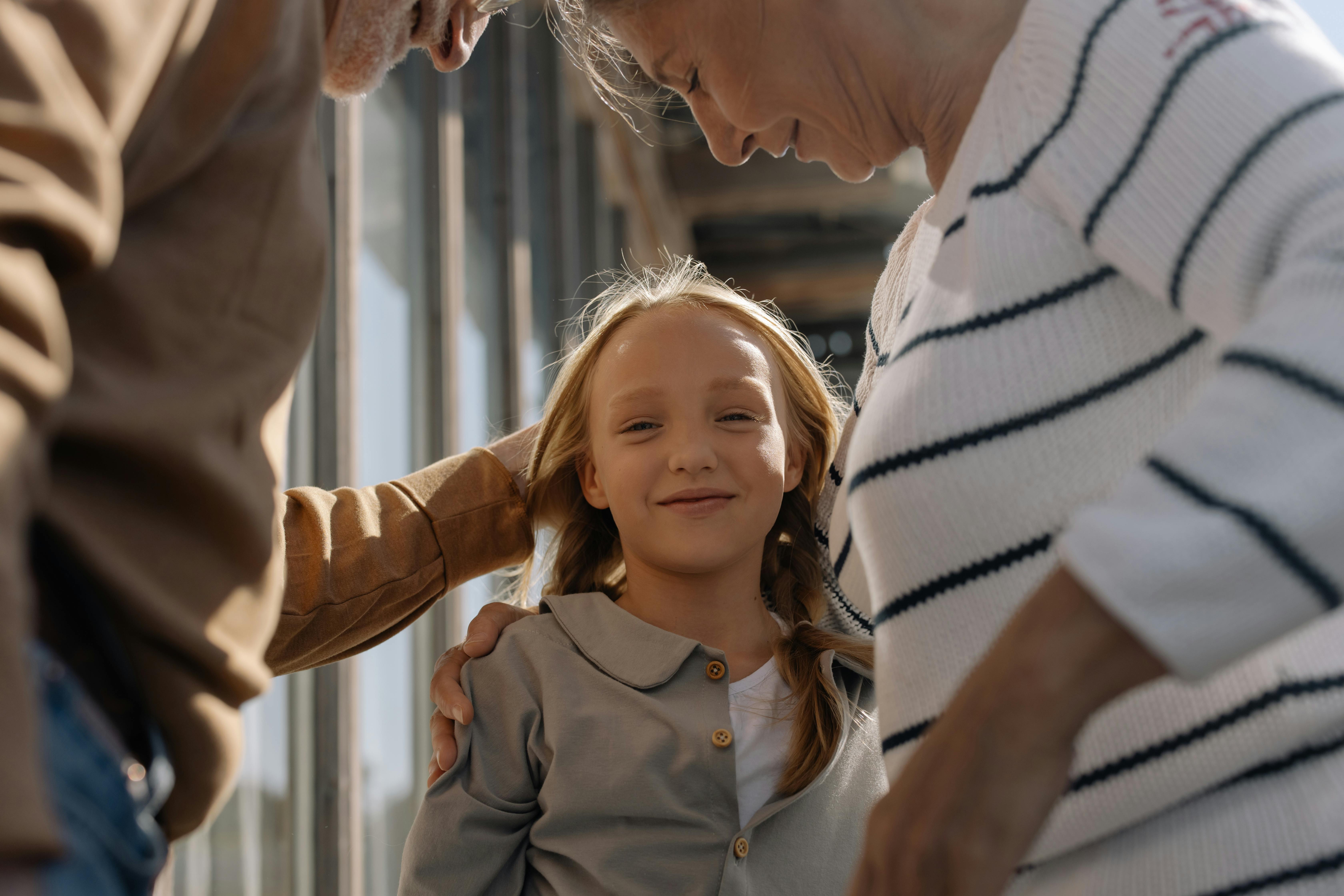 Grandparents with their granddaughter | Source: Pexels