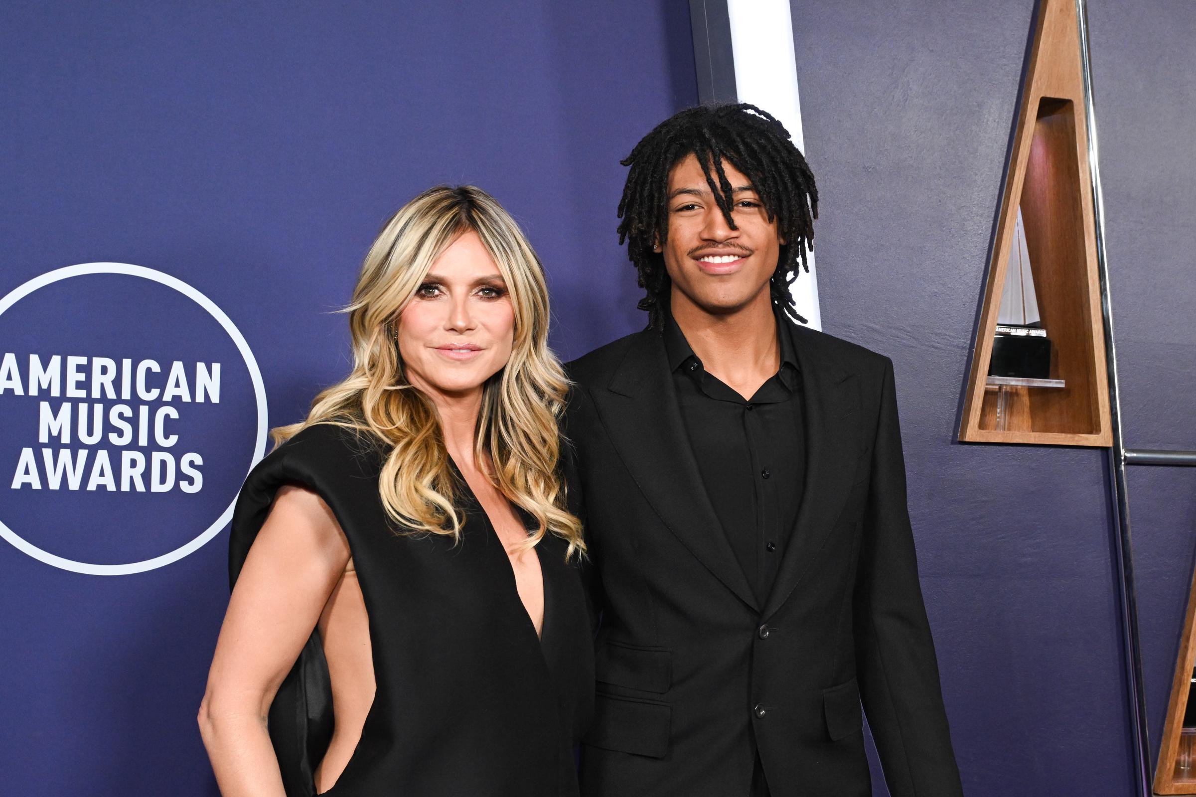 Heidi Klum and her son, Henry Samuel, pose side by side at the 2025 AMAs. With coordinated black outfits and confident smiles, the duo stood out among the night's celebrity arrivals.