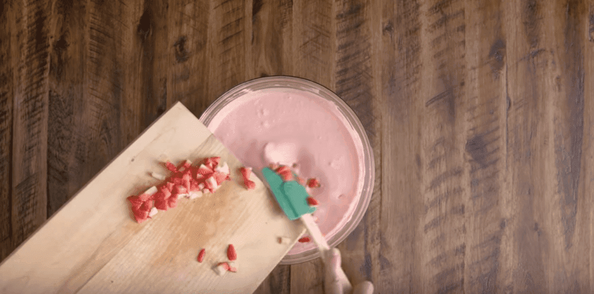 Add the sliced strawberries to the Whip and Jell-O mixture. Image credit: YouTube/Kraft Recipes