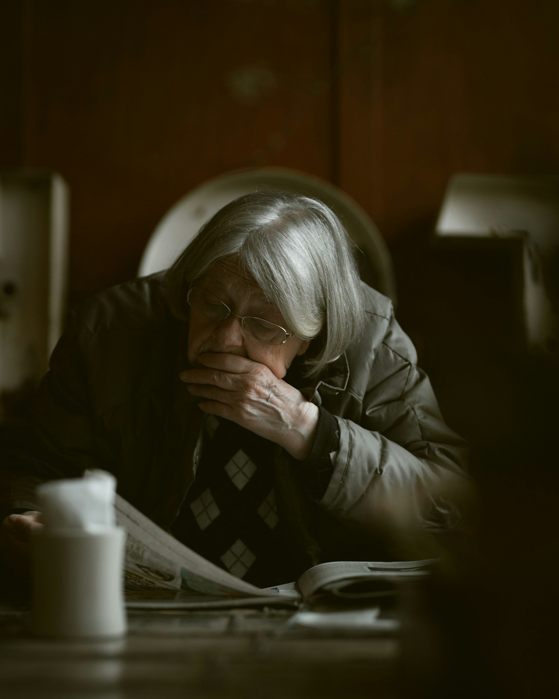 An older woman seated at a table | Source: Unsplash