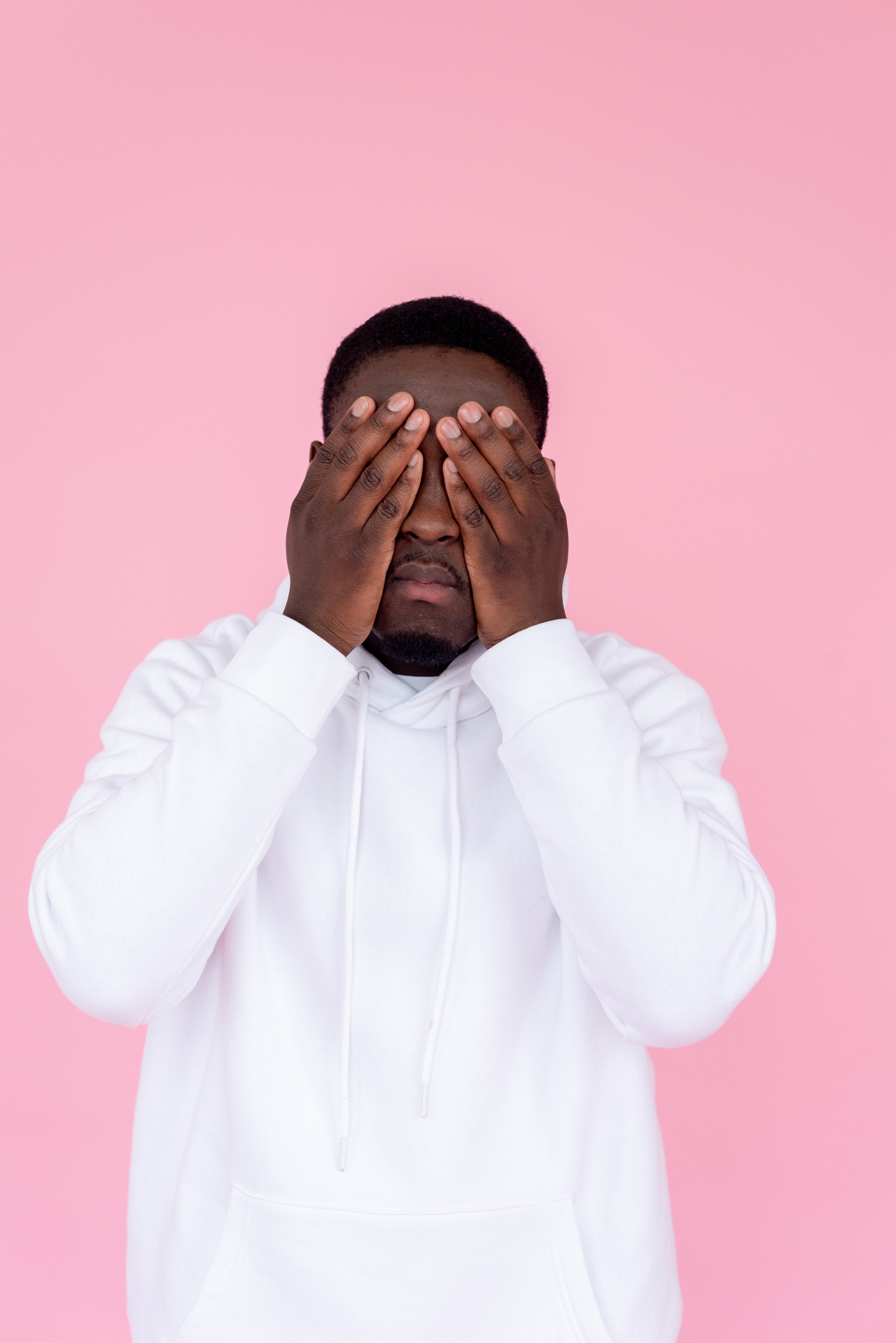 Sad black man covering his hands with face | Photo: Pexels