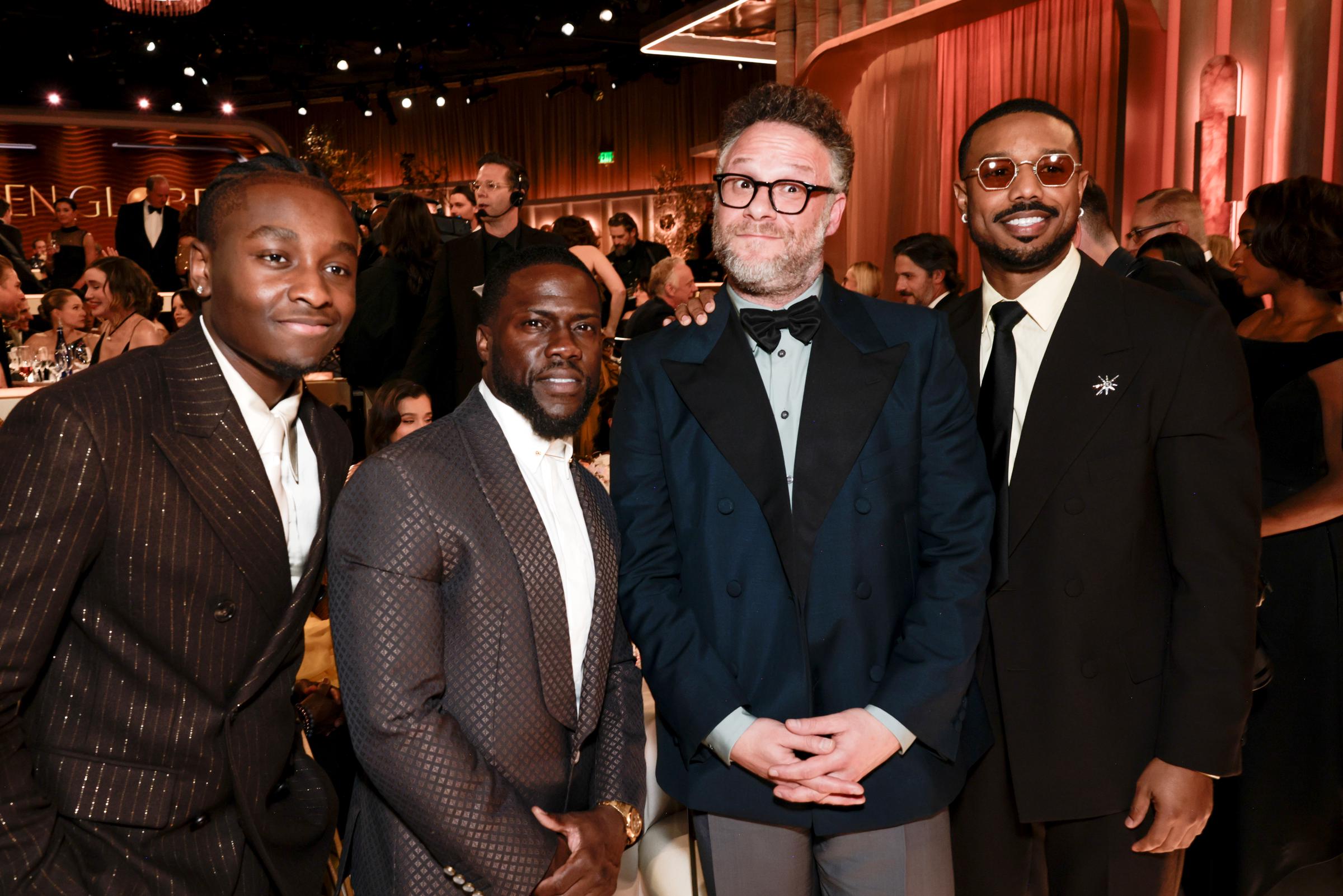 Miles Caton, Kevin Hart, Seth Rogen, and Michael B. Jordan gather for a group photo mid-ceremony, each flashing big grins and stylish suits, radiating effortlessly cool vibes during the awards night.