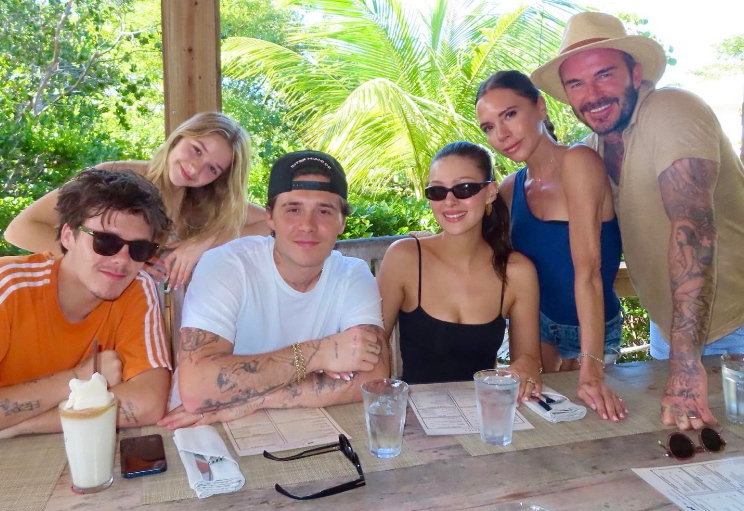 Victoria, David, Brooklyn, Cruz, and Harper Beckham, and Nicola Peltz at a resort in a post dated December 25, 2023 | Source: Instagram/victoriabeckham