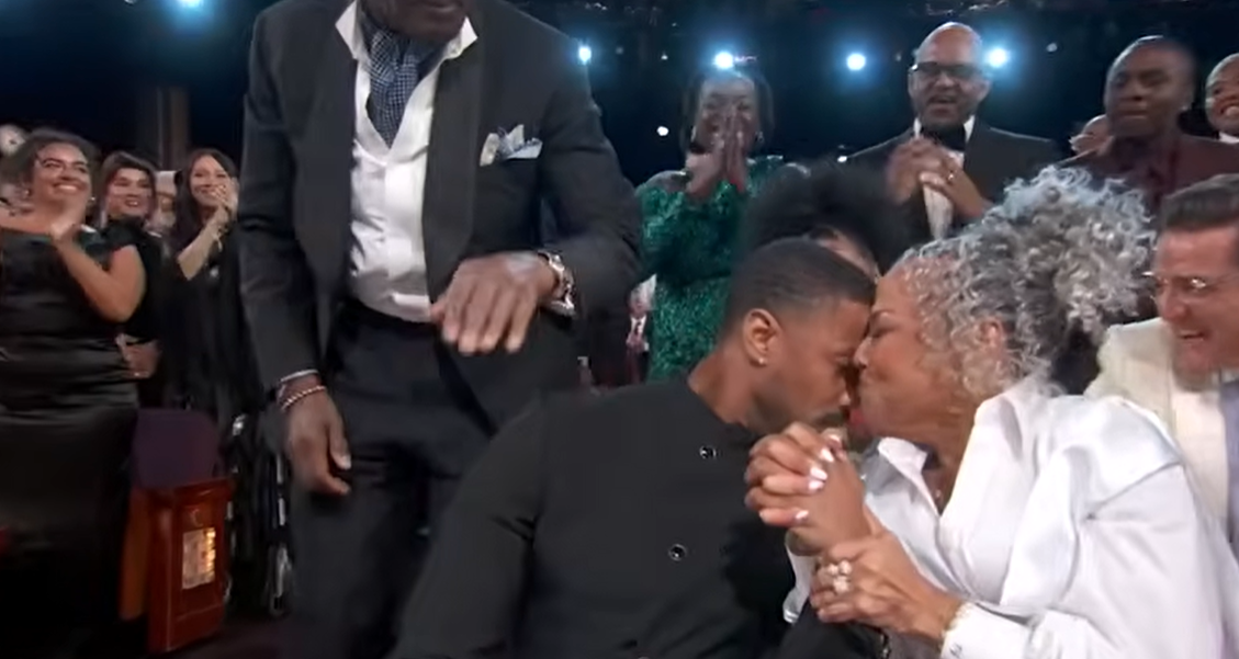 Donna Jordan presses a heartfelt kiss to her son’s face while holding his hand as the room erupts around them. | Source: YouTube/ABCNews