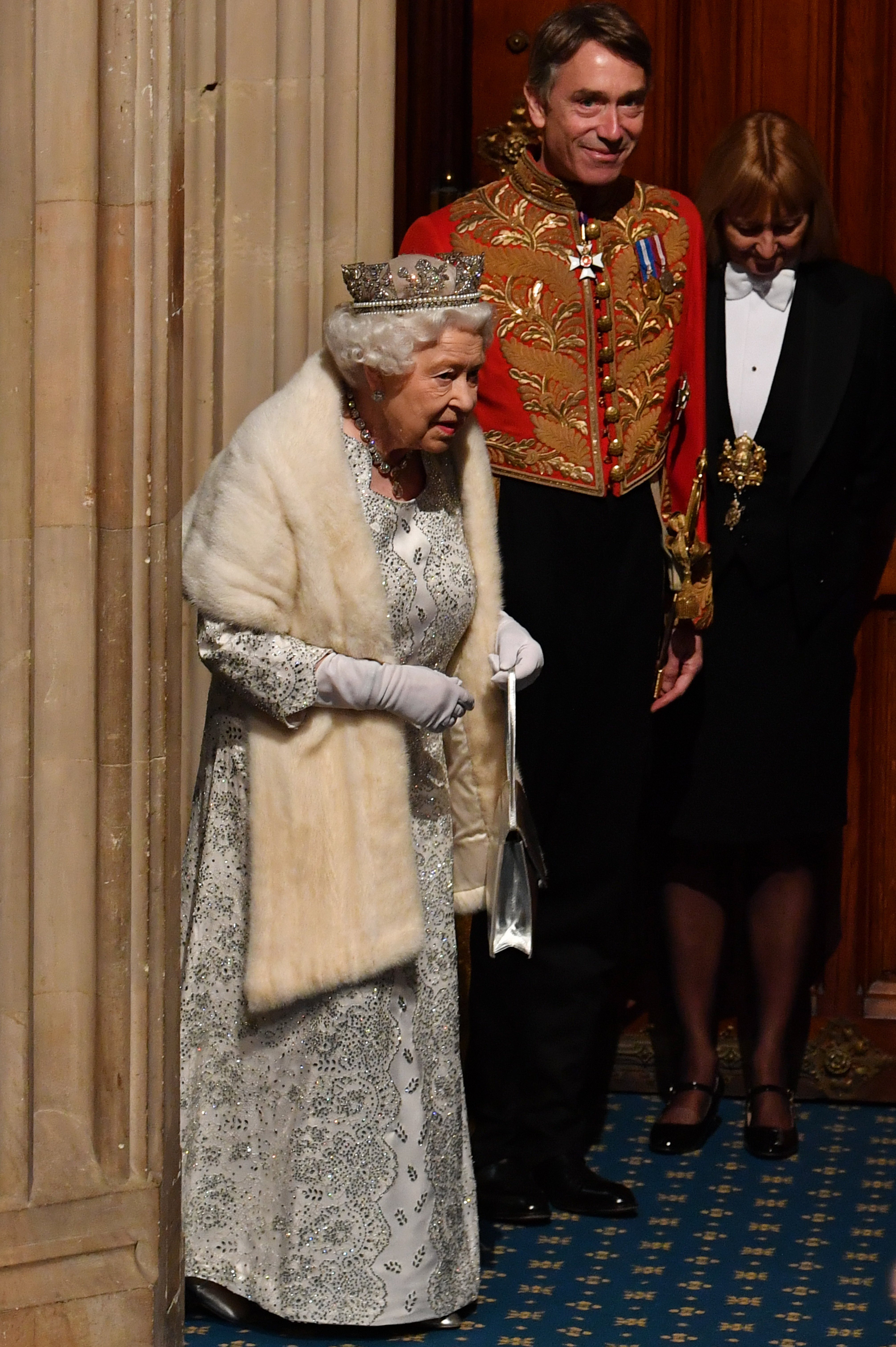 Queen Elizabeth II (L) arrives with David Cholmondeley, Marquess of Cholmondeley, (2L) to attend the State Opening of Parliament at the Palace of Westminster on October 14, 2019, in London, England. | Source: Getty Images.