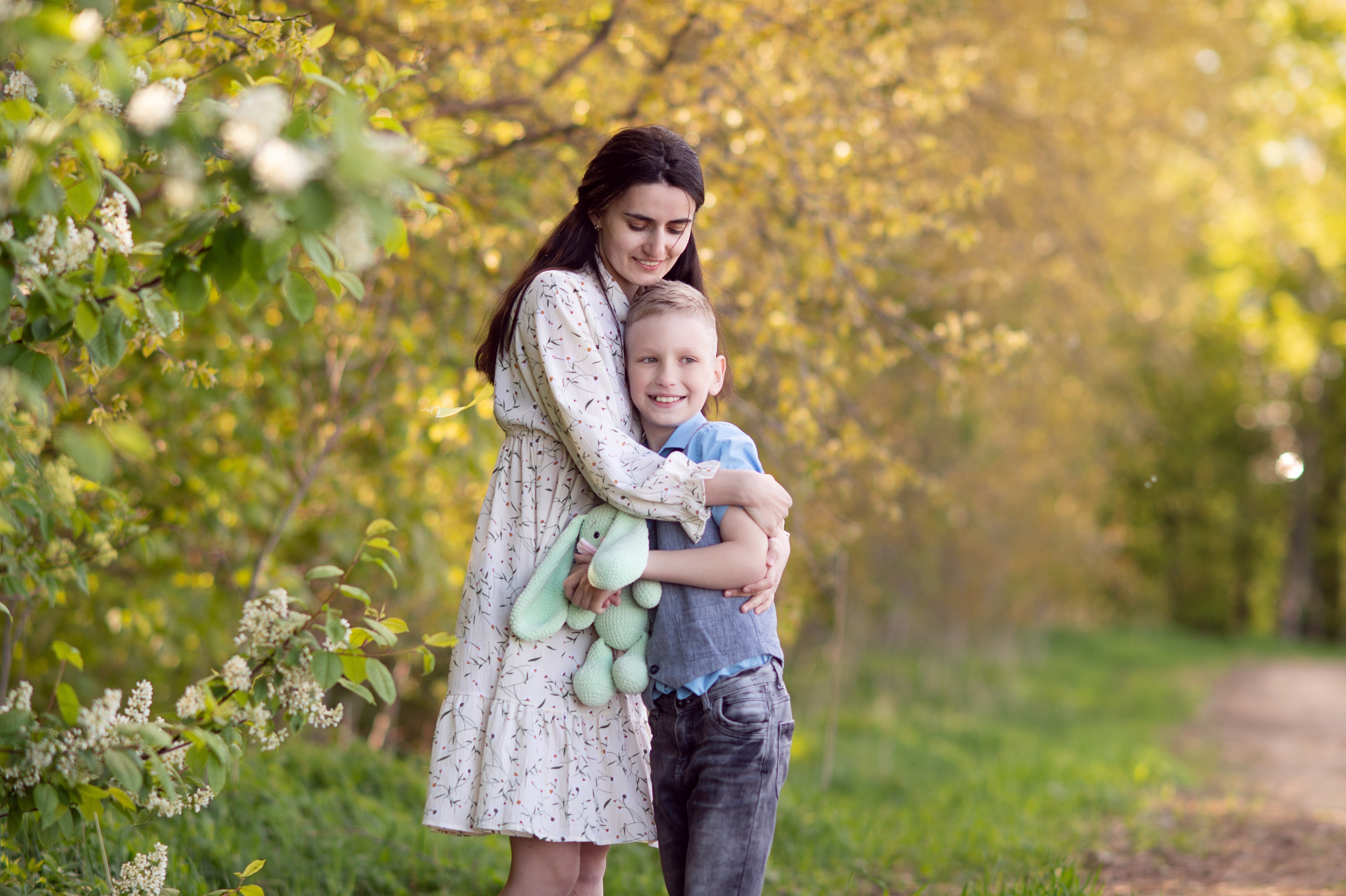 A mother and son hugging in a park | Source: Shutterstock