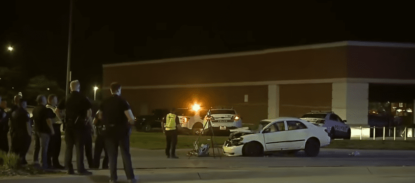 Police officers surround the crashed car. | Source: youtube.com/KETV NewsWatch 7
