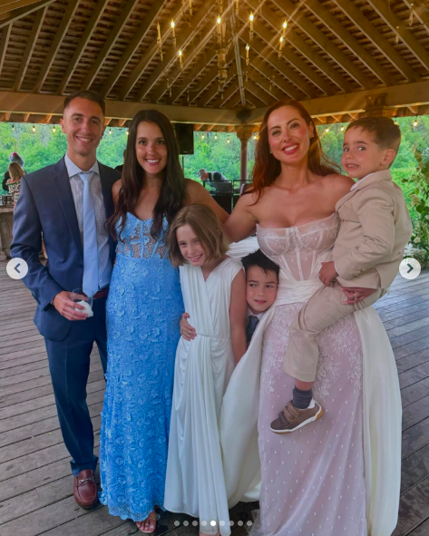 Eva Amurri, Marlowe, Major and Mateo Martino posing for a picture with guests on Eva Amurri's wedding day, posted on July 2, 2024 | Source: Instagram/bri_austen