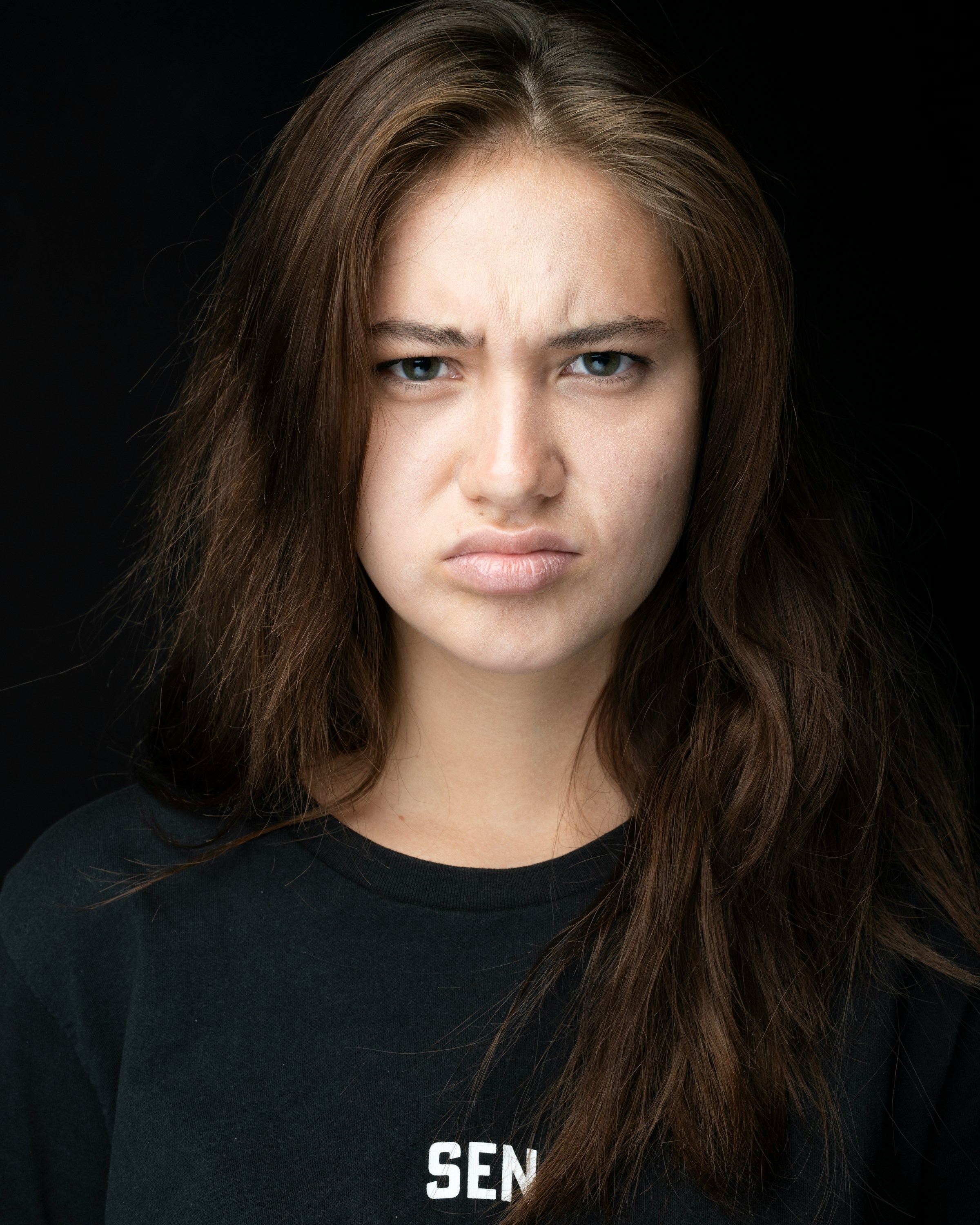 A frowning woman wearing black | Source: Unsplash