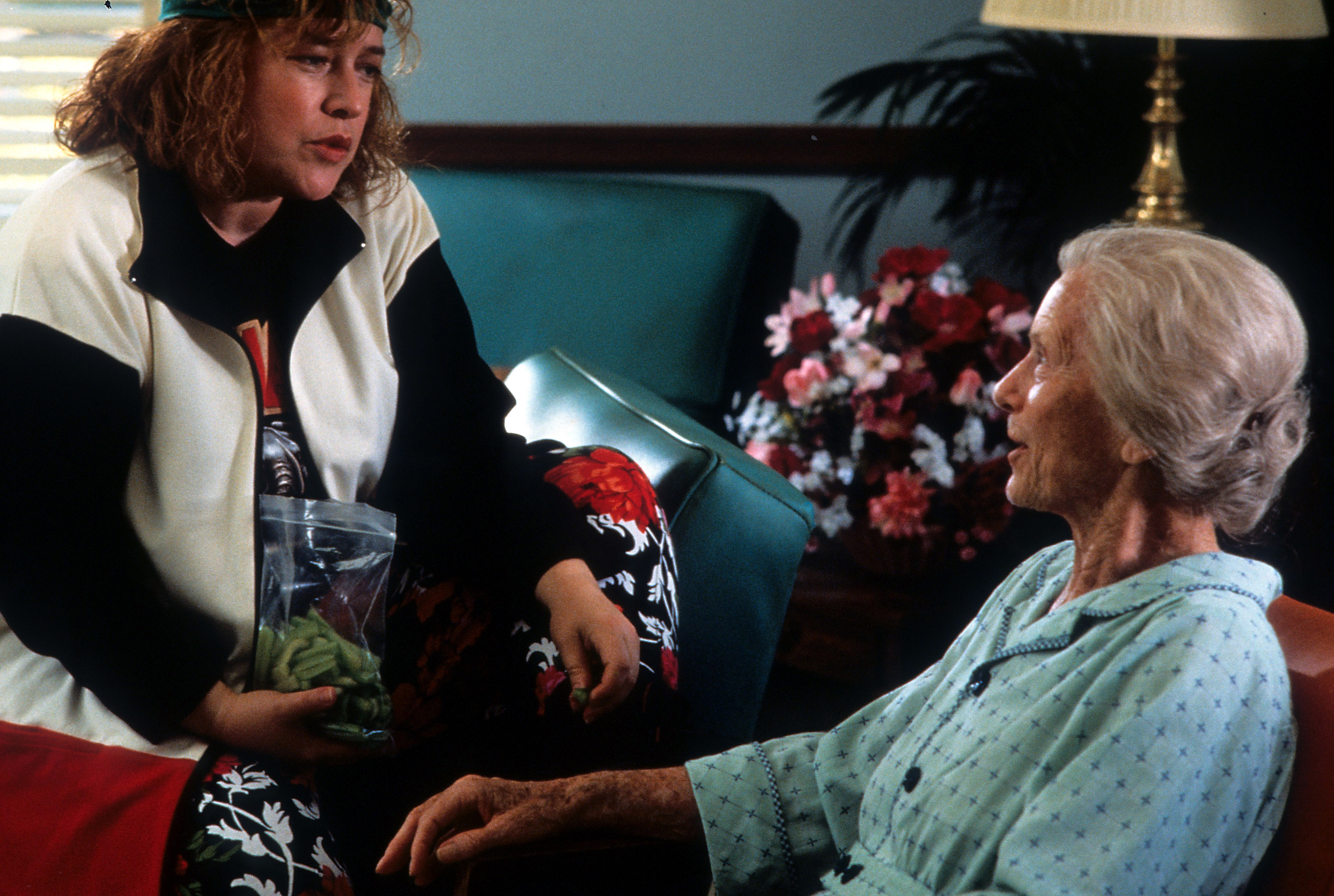 Kathy Bates sitting on a couch with Jessica Tandy in a scene from the film "Fried Green Tomatoes" in 1991 | Source: Getty Images