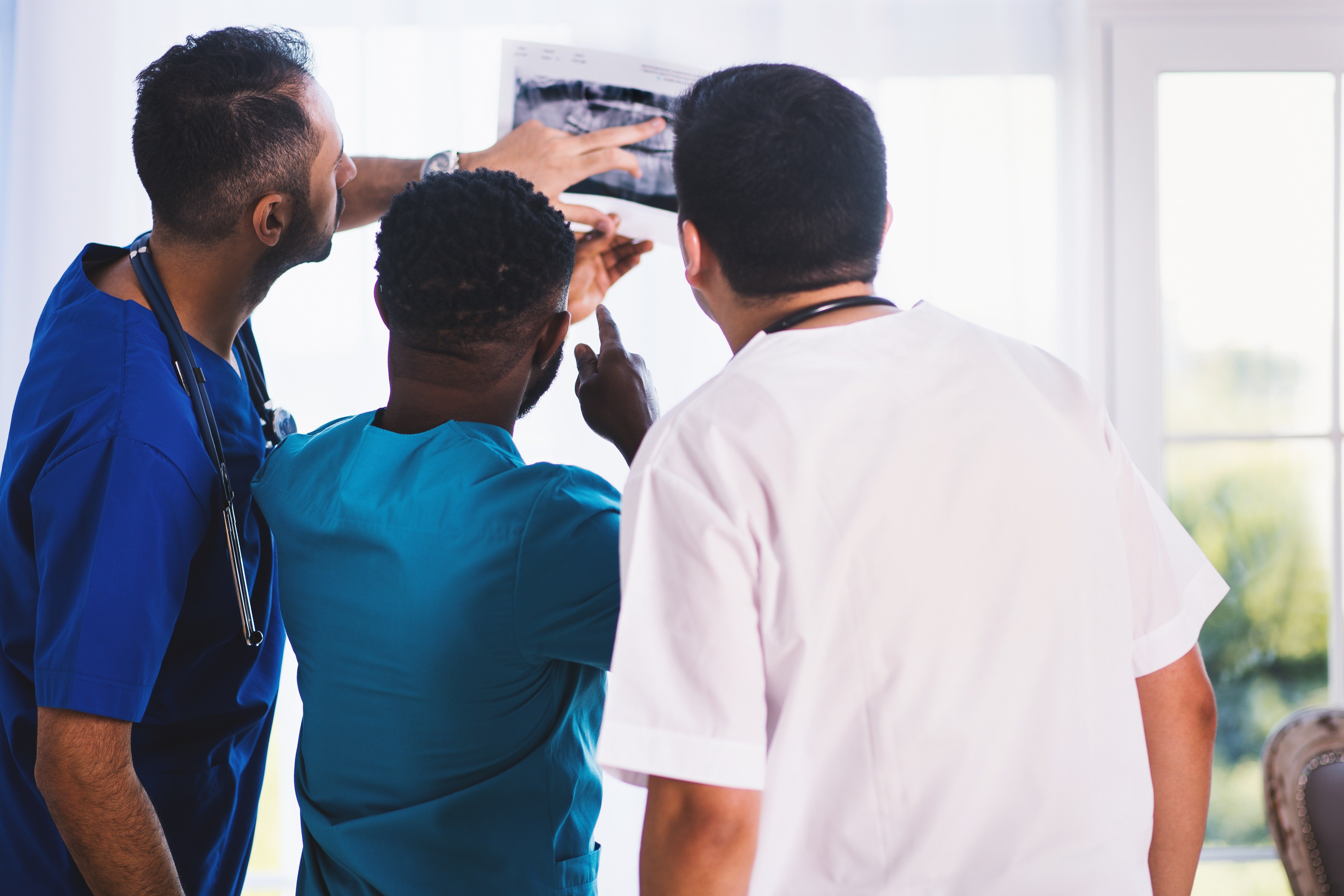 Doctor's examining an x-ray report. | Source: Pexels