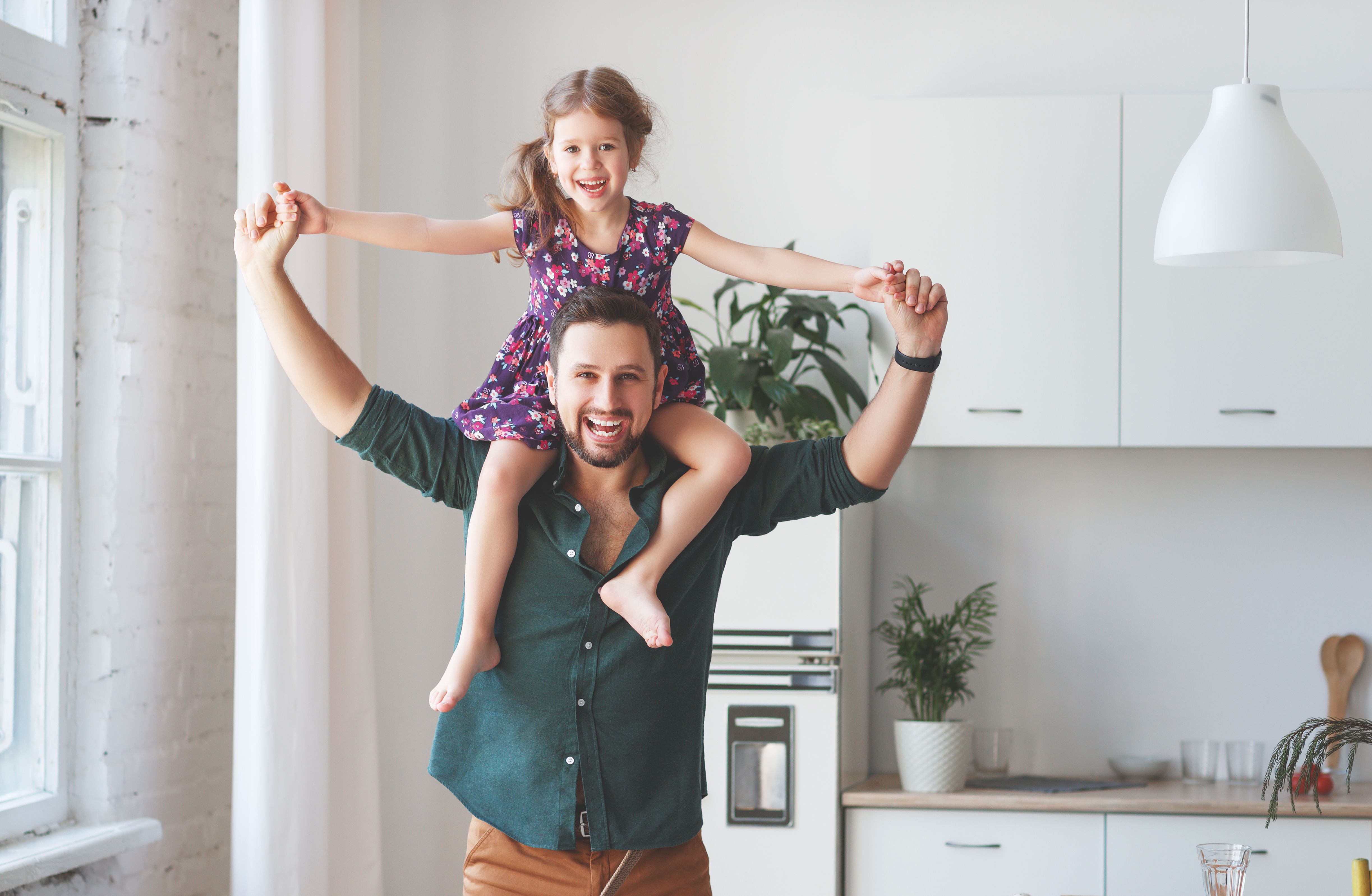 A father and his daughter playing in the living room. | Source: Shutterstock