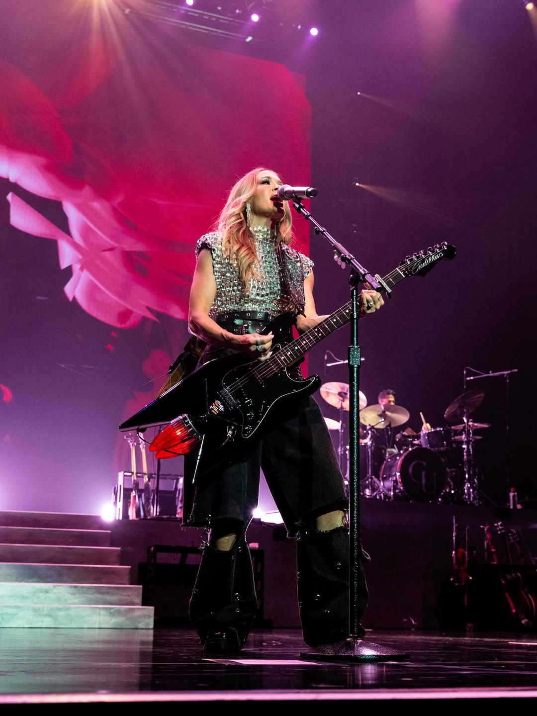 Carrie Underwood plays guitar while performing onstage in Lincoln, California, on June 14, 2026 | Source: Instagram/carrieunderwood