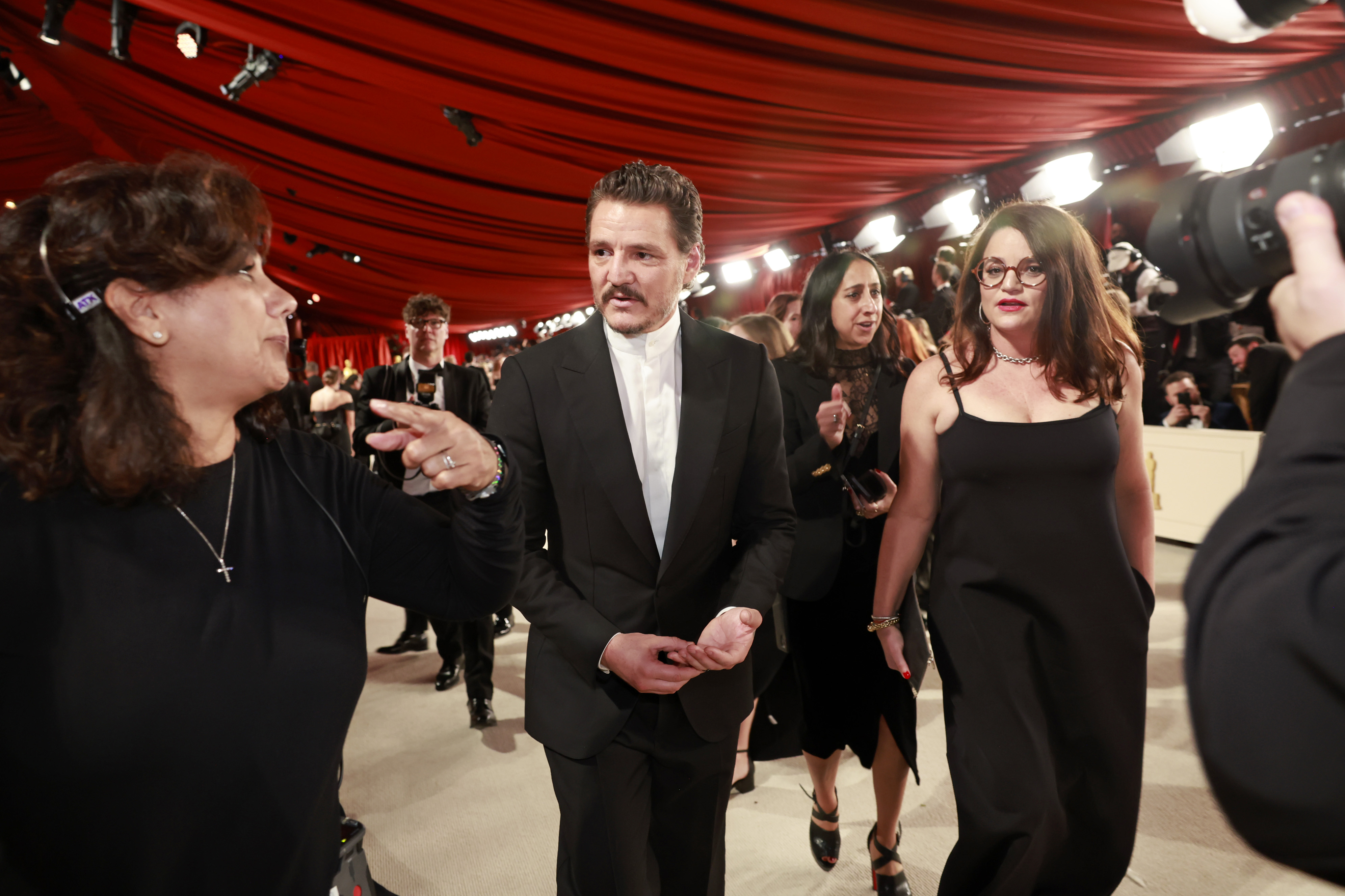 Pedro Pascal and Javiera Balmaceda being directed at the 95th Annual Academy Awards in Hollywood, California, on March 12, 2023. | Source: Getty Images