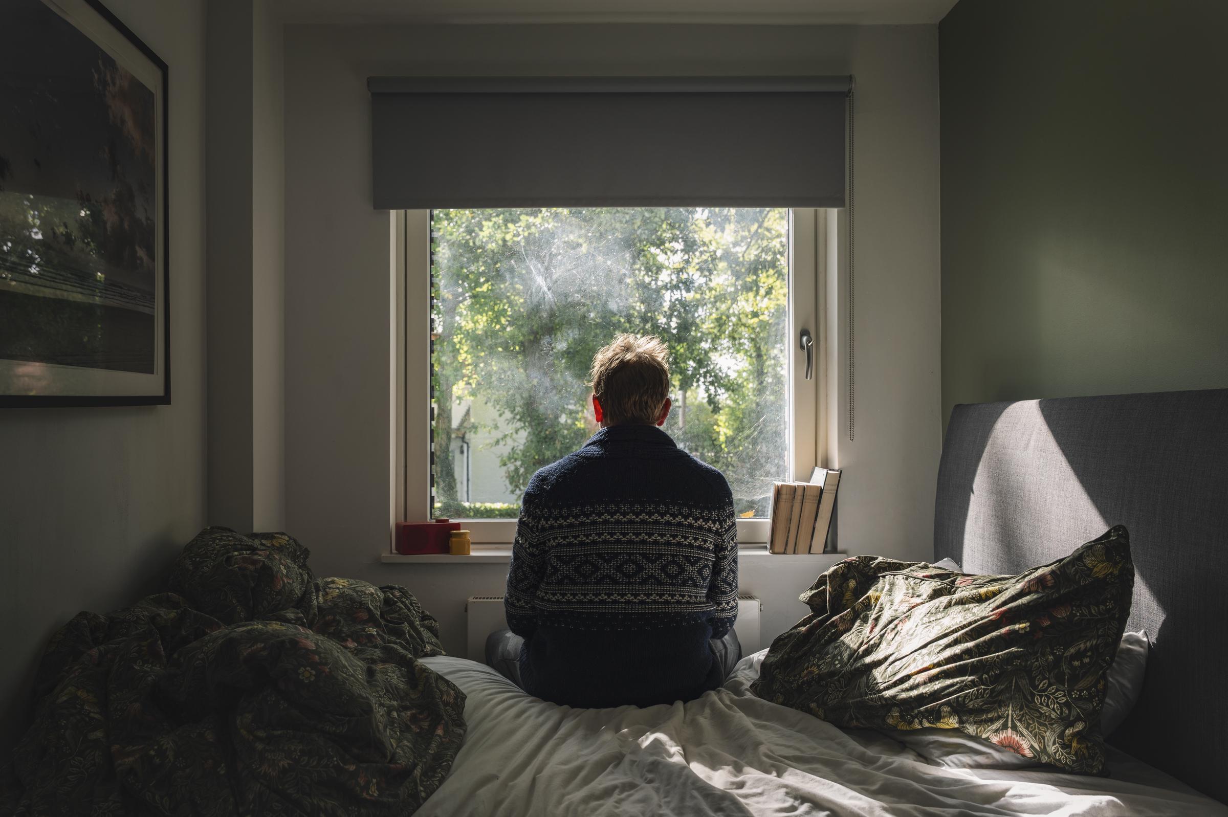 A rear view of a man looking out his window | Source: Getty Images