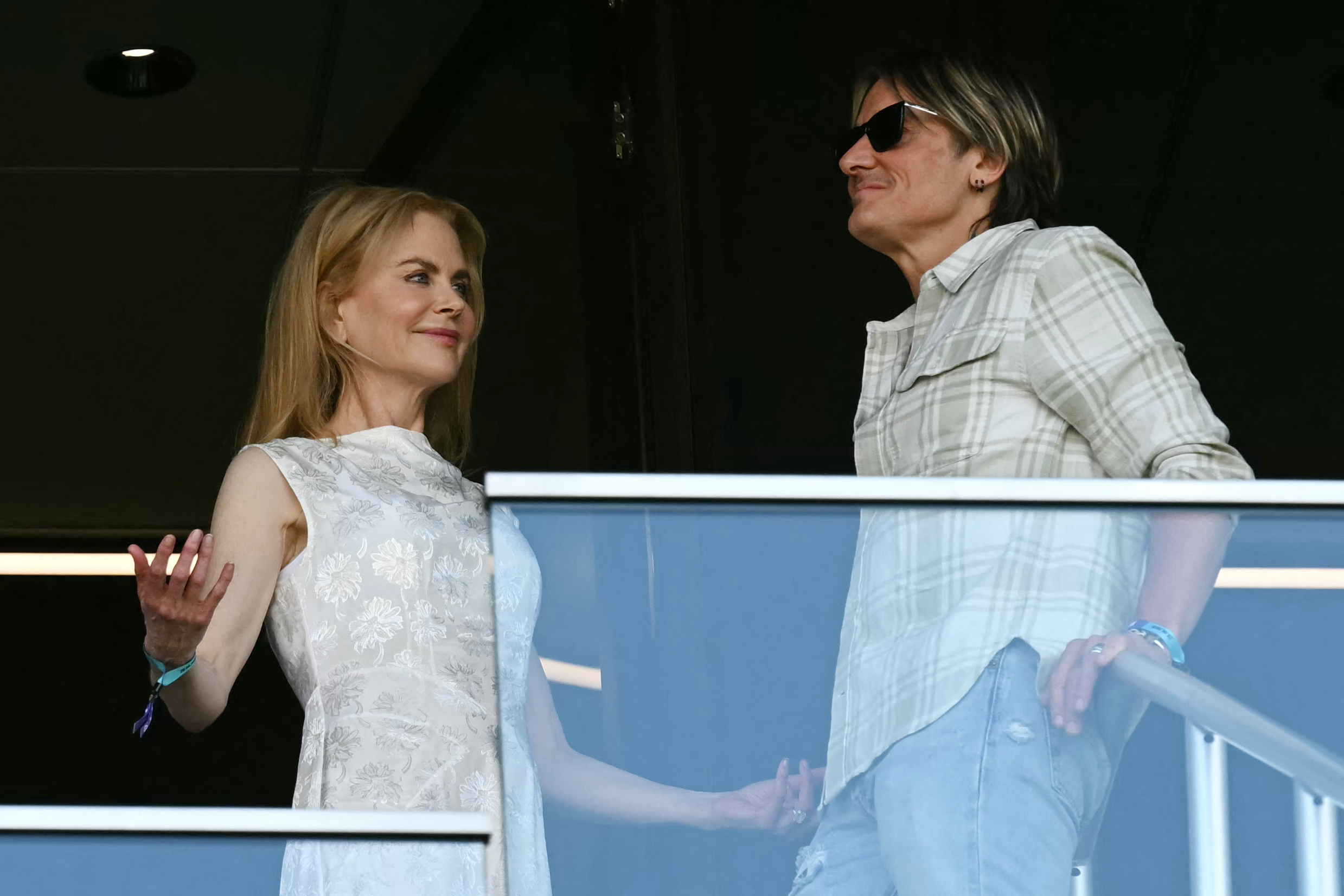 Nicole Kidman and Keith Urban smile at each other inside their box suite, her hand mid-gesture as they share a lighthearted exchange during the FIFA Club World Cup match.