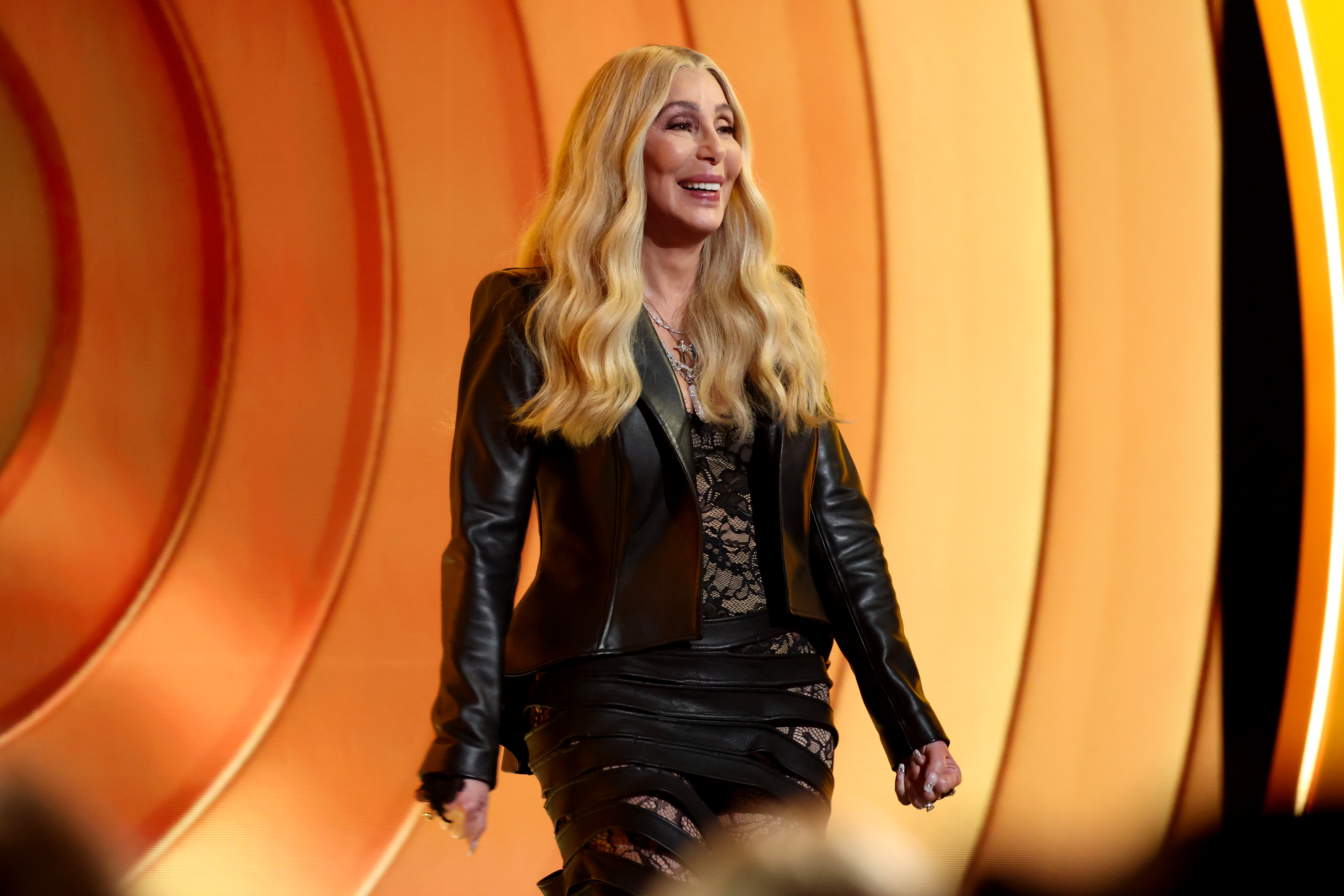 Cher walks onto the stage smiling as she prepares to speak during the 68th Grammy Awards in Los Angeles on February 1, 2026 | Source: Getty Images