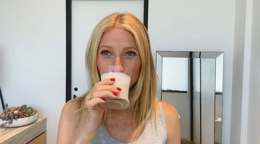 Gwyneth Paltrow drinks a protein smoothie while demonstrating her morning wellness routine in a video dated March 30, 2021. | Source: YouTube/Vogue