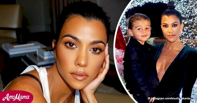 Kourtney Kardashian flaunts her chest in a very risqué low-cut dress holding her son in her arms