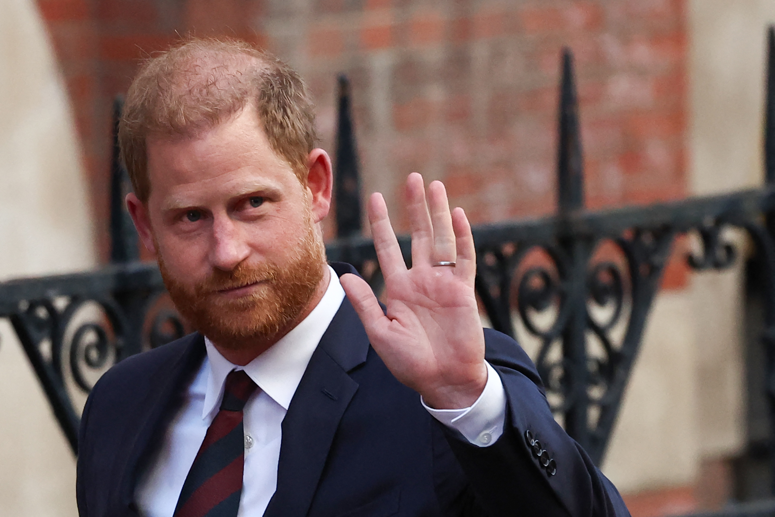 Prince Harry, Duke of Sussex waves as he departs the the Royal Courts of Justice, Britain's High Court, in central London, on April 9, 2025. | Source: Getty Images