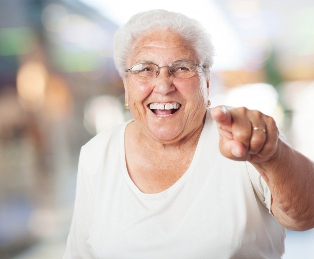 Senior woman pointing and laughing