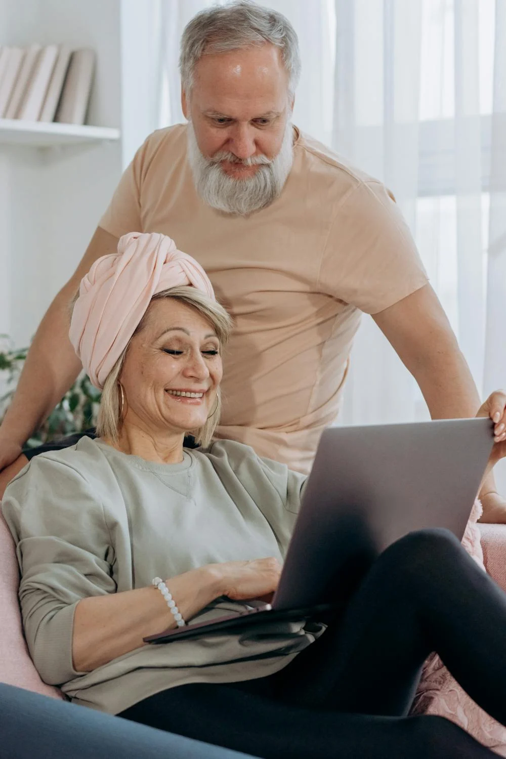 A happy mature couple looking at their laptop | Source: Pexels