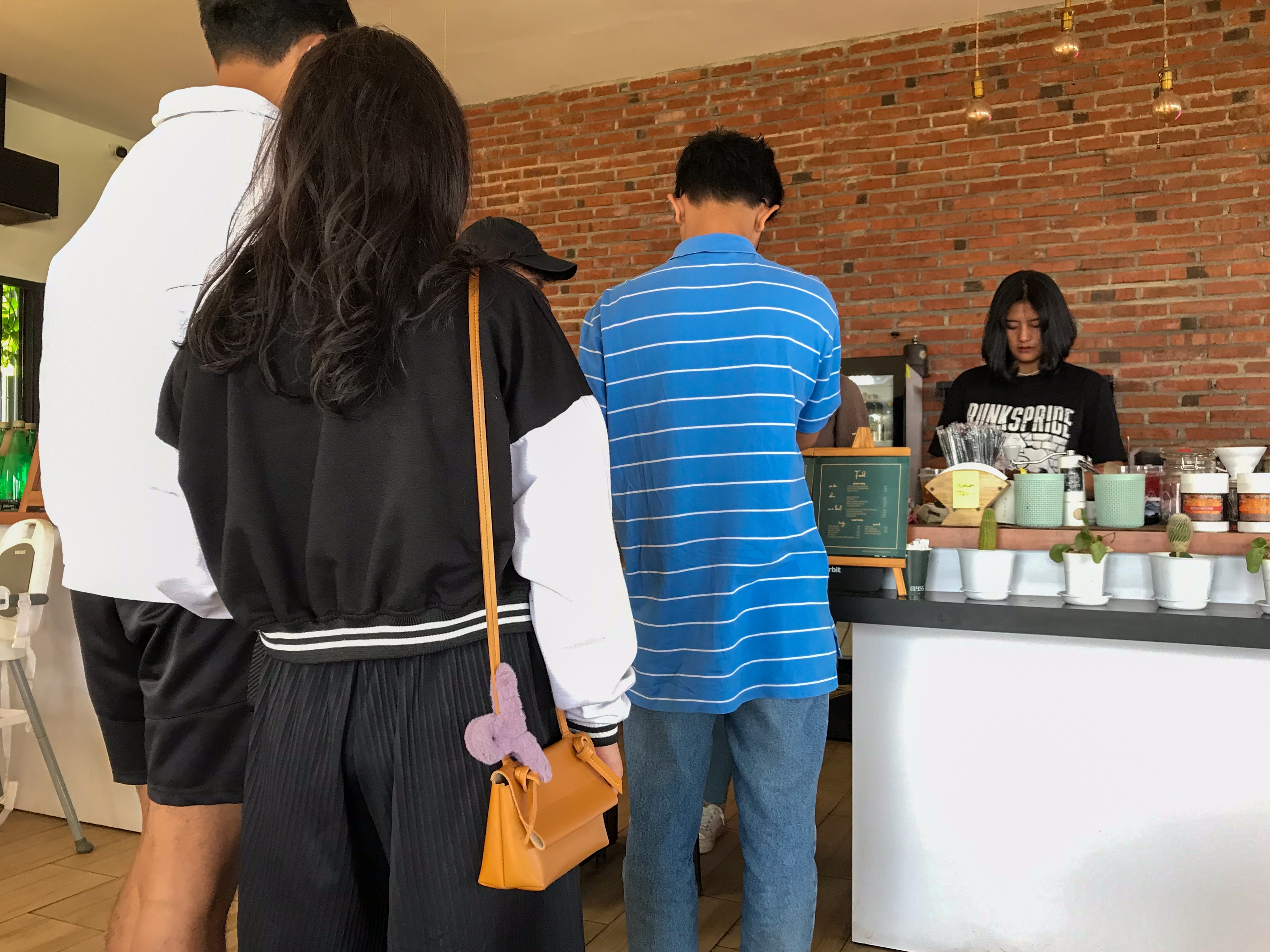 People queueing at a coffee shop | Source: Shutterstock