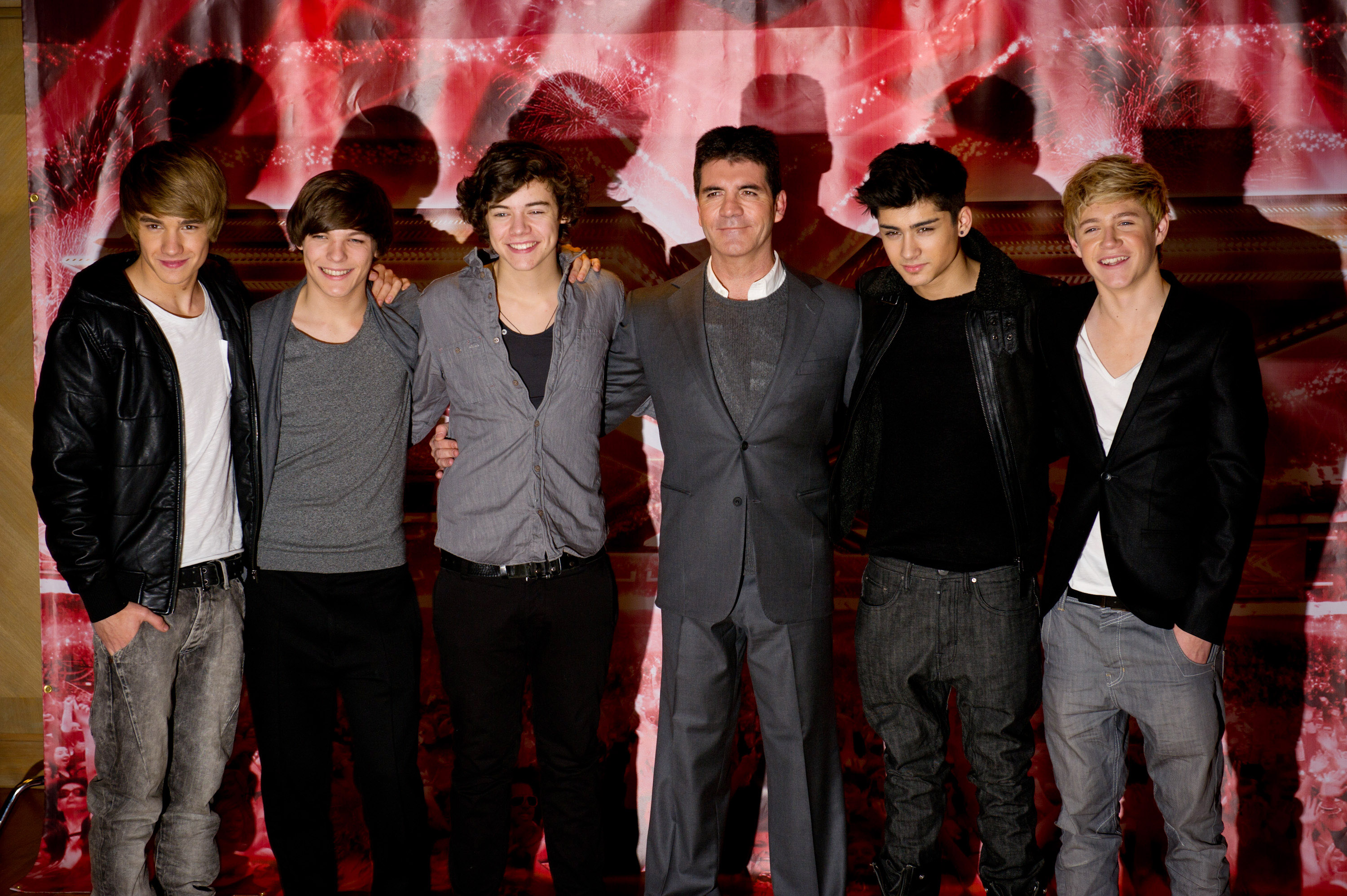 Liam Payne, Louis Tomlinson, Harry Styles, Zayn Malik, and Niall Horan of One Direction with Simon Cowell at a photocall during "The X Factor" press conference on December 9, 2010, in London, England. | Source: Getty Images