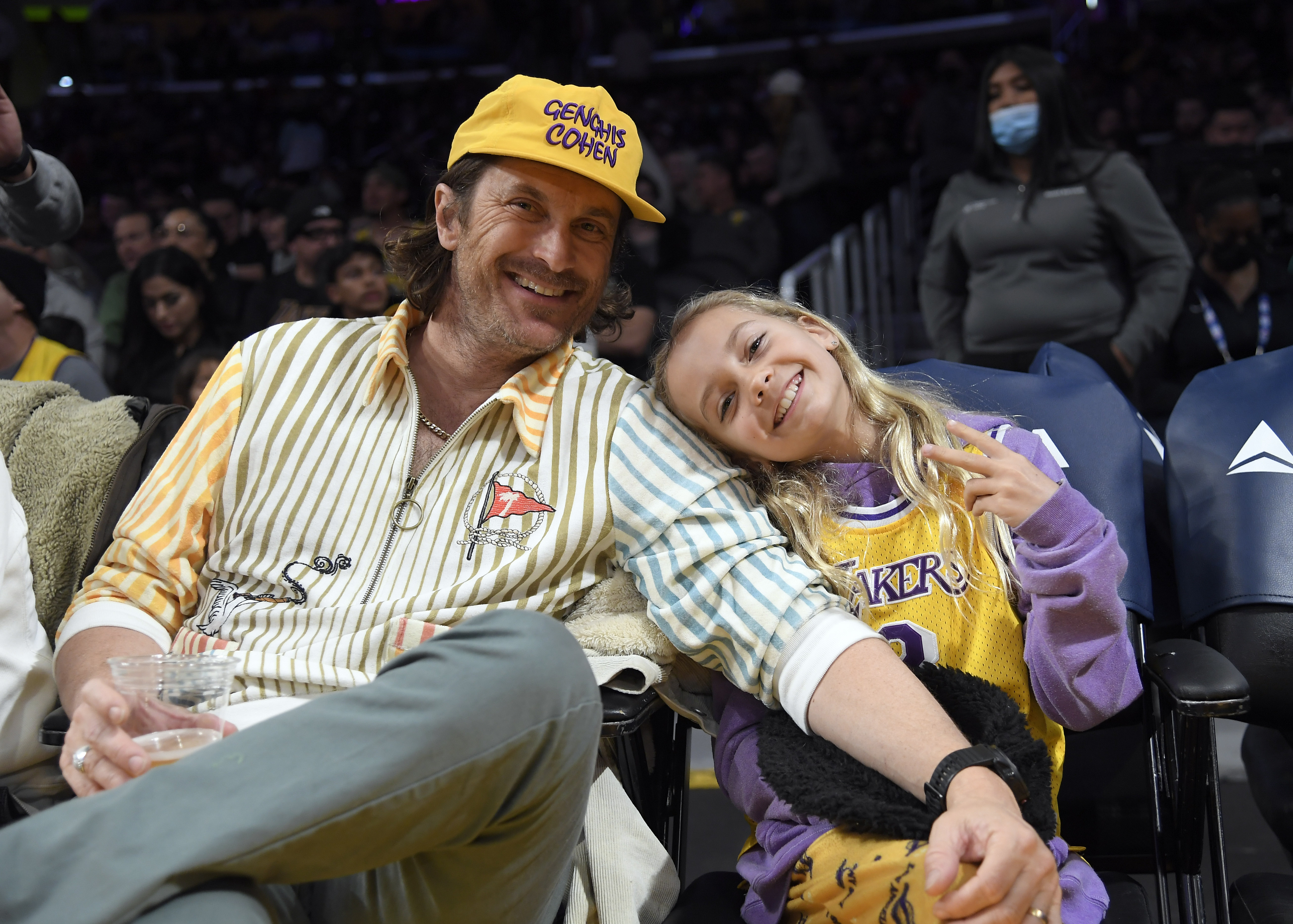 Sporting a Lakers jersey, Rio Hudson joined her dad Oliver Hudson for a night of basketball at Crypto.com Arena on March 10, 2023. The pair took in the Lakers vs. Raptors game, sharing laughs and team pride from their courtside seats.