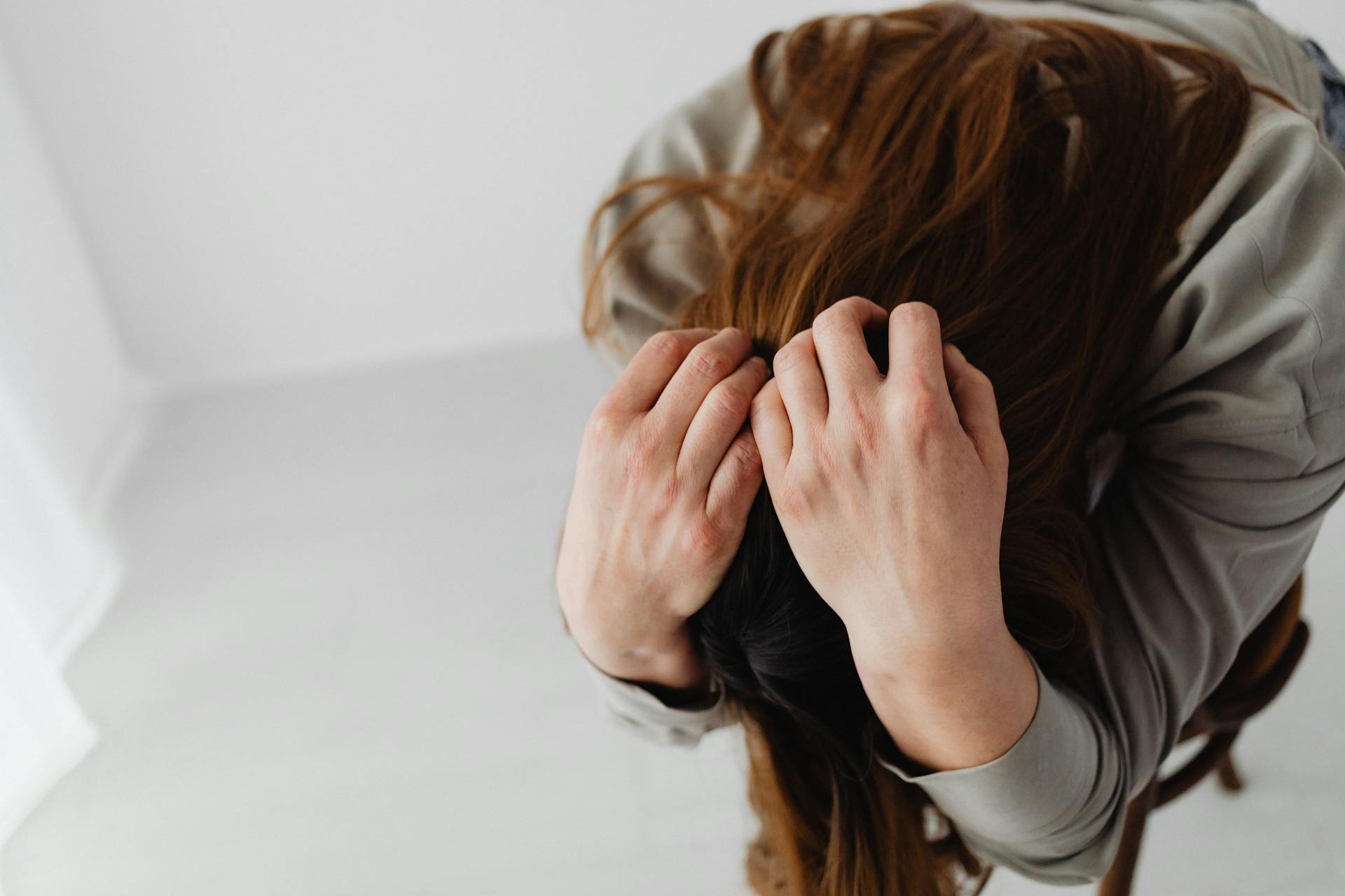 A sad woman with hands on her head | Source: Pexels