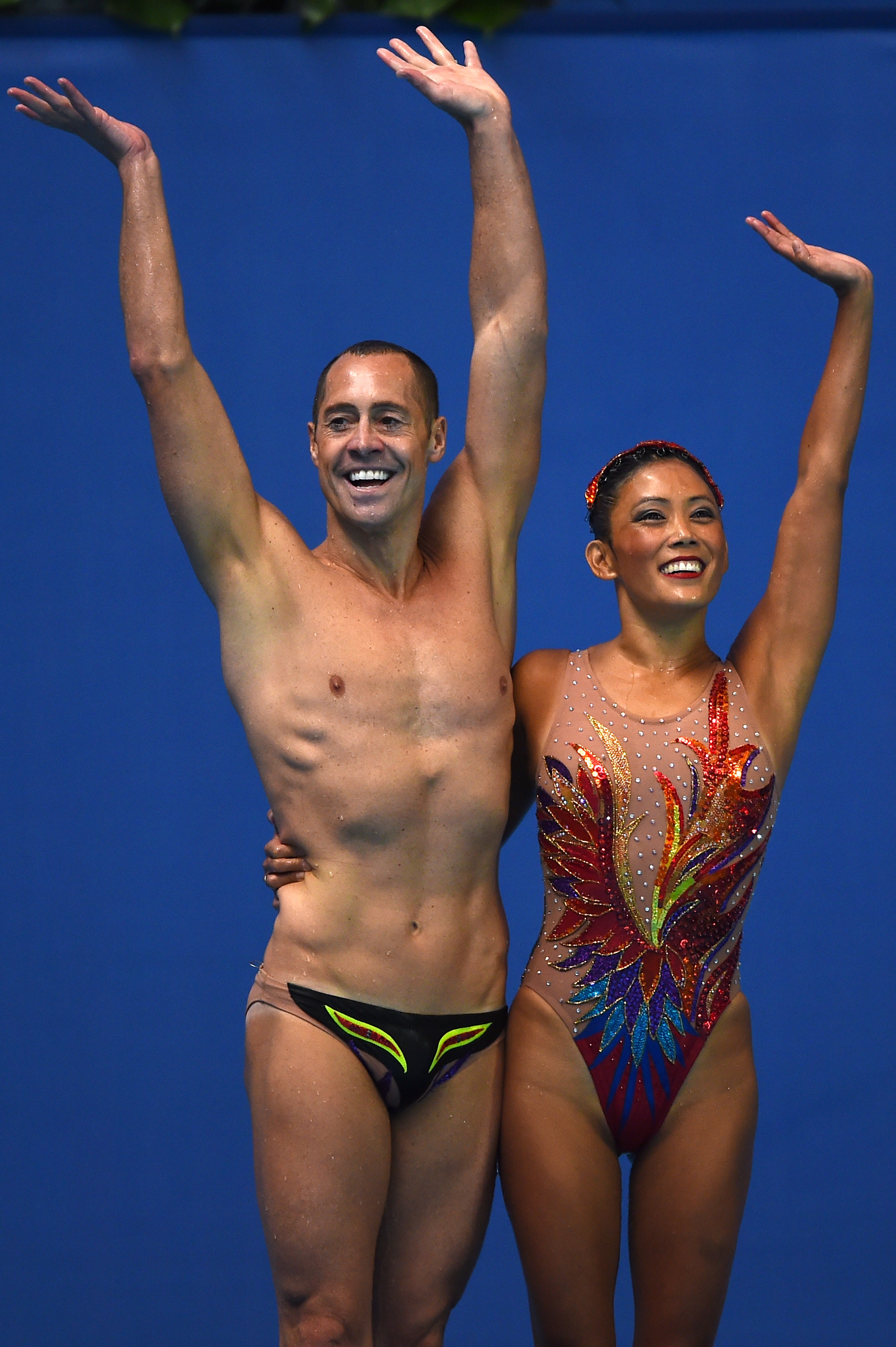 US mixed duet Kristina Lum-Underwood and Bill May waving after competing in the Mixed Duet Free preliminary event at the 2015 FINA World Championships in Kazan, on July 28, 2015 | Source: Getty Images