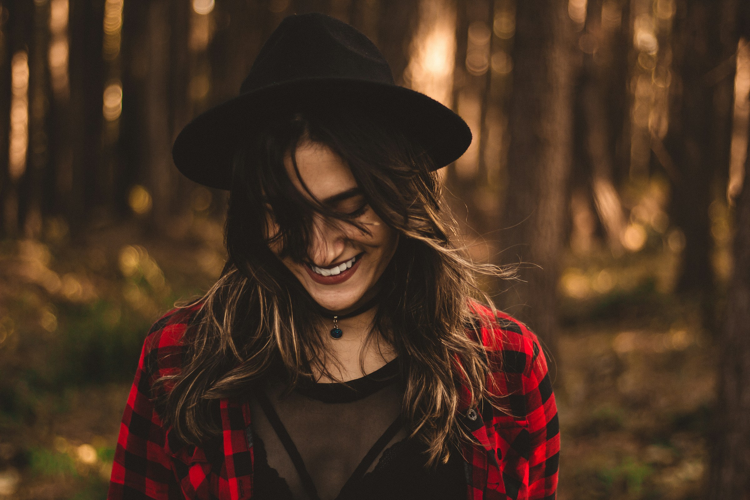 A woman smiling in the forest | Source: Unsplash