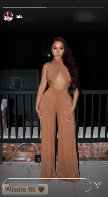 La La Anthony posing for a picture in a nude cropped top and matching pants | Photo: Instagram/lala
