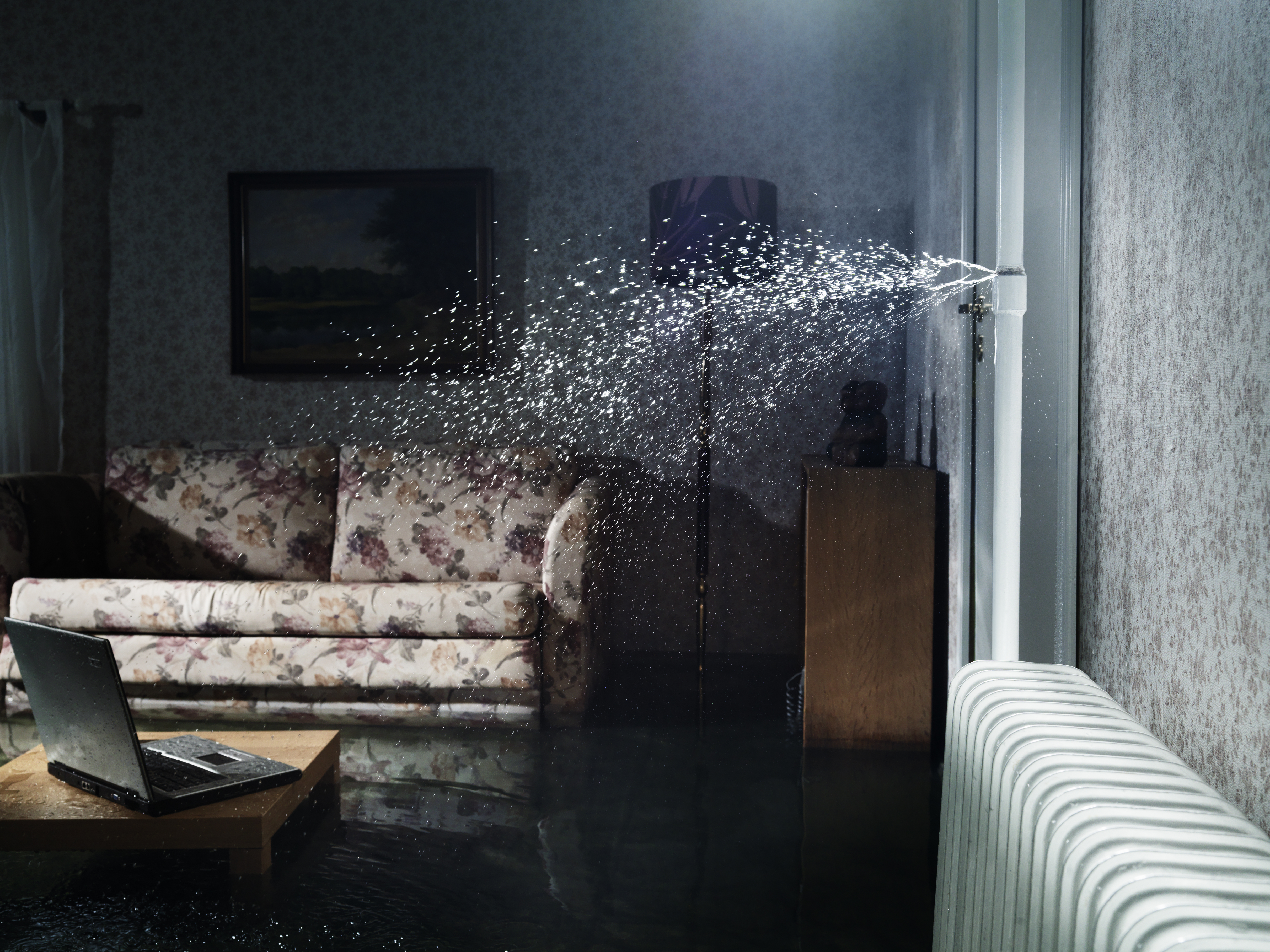 Water splashing inside a room through a broken pipe | Source: Getty Images