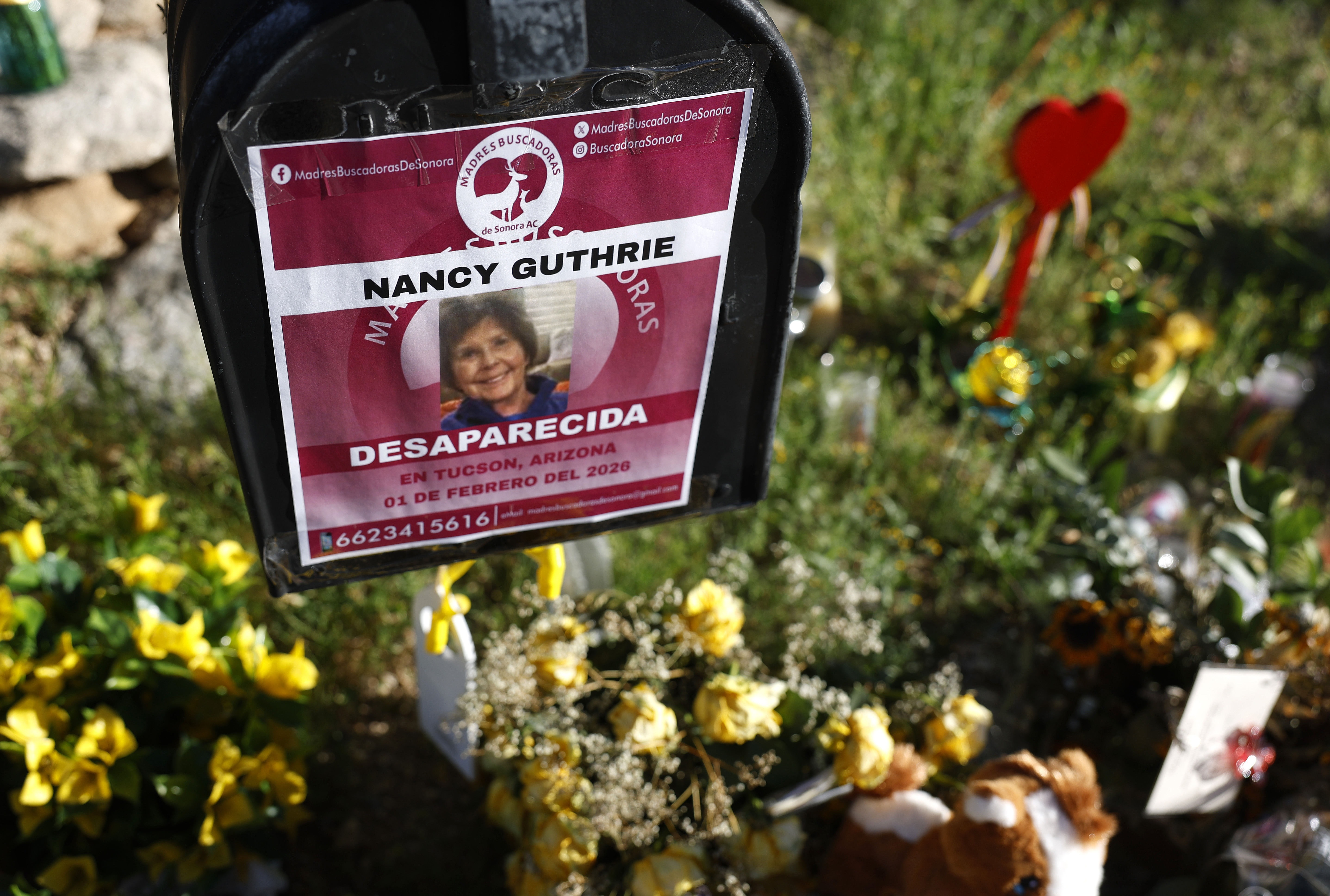Flowers and signs are seen at a memorial outside Nancy Guthrie's home on February 27, 2026, in Tucson, Arizona | Source: Getty Images
