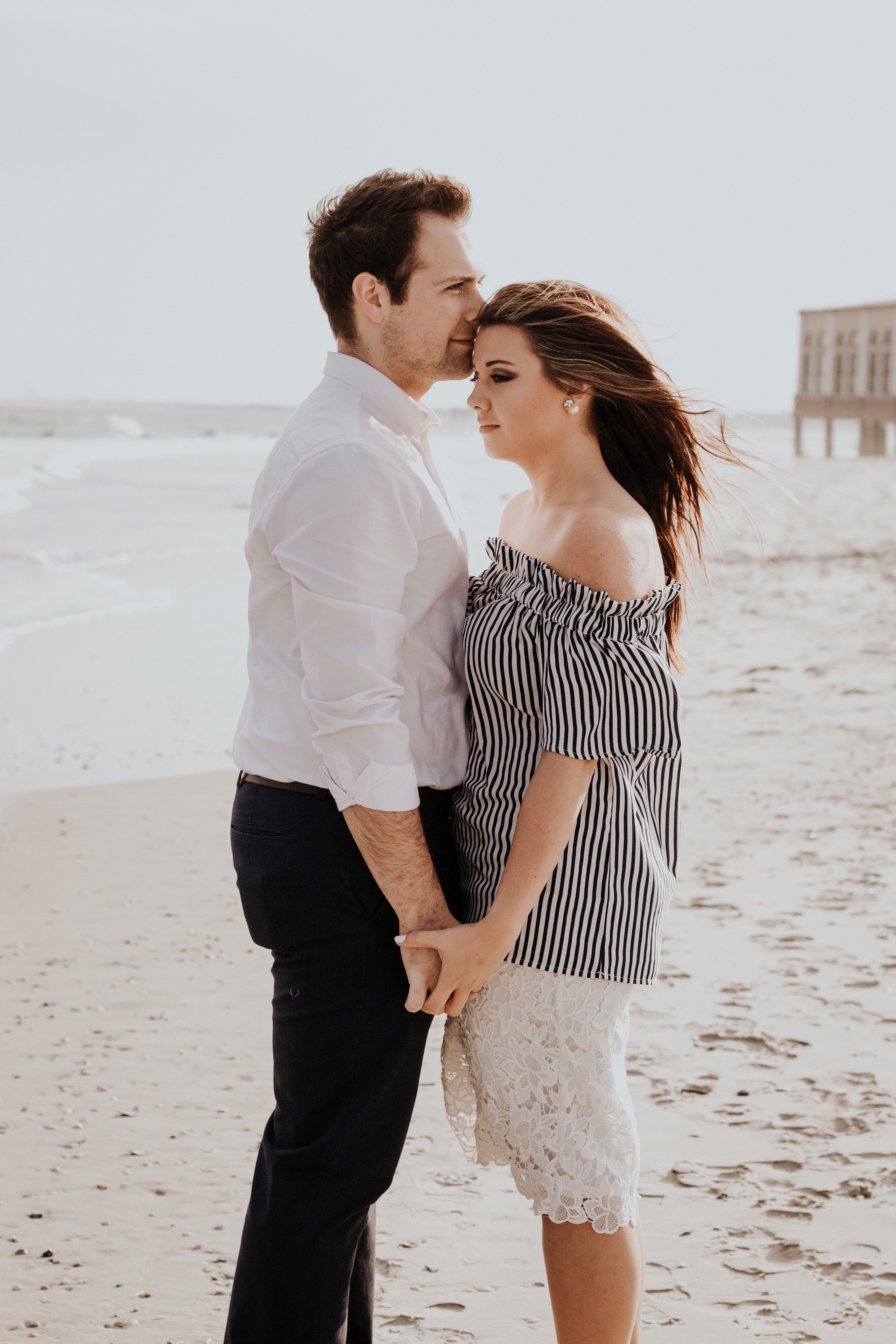 A man kissing a woman on the forehead  | Source: Unsplash