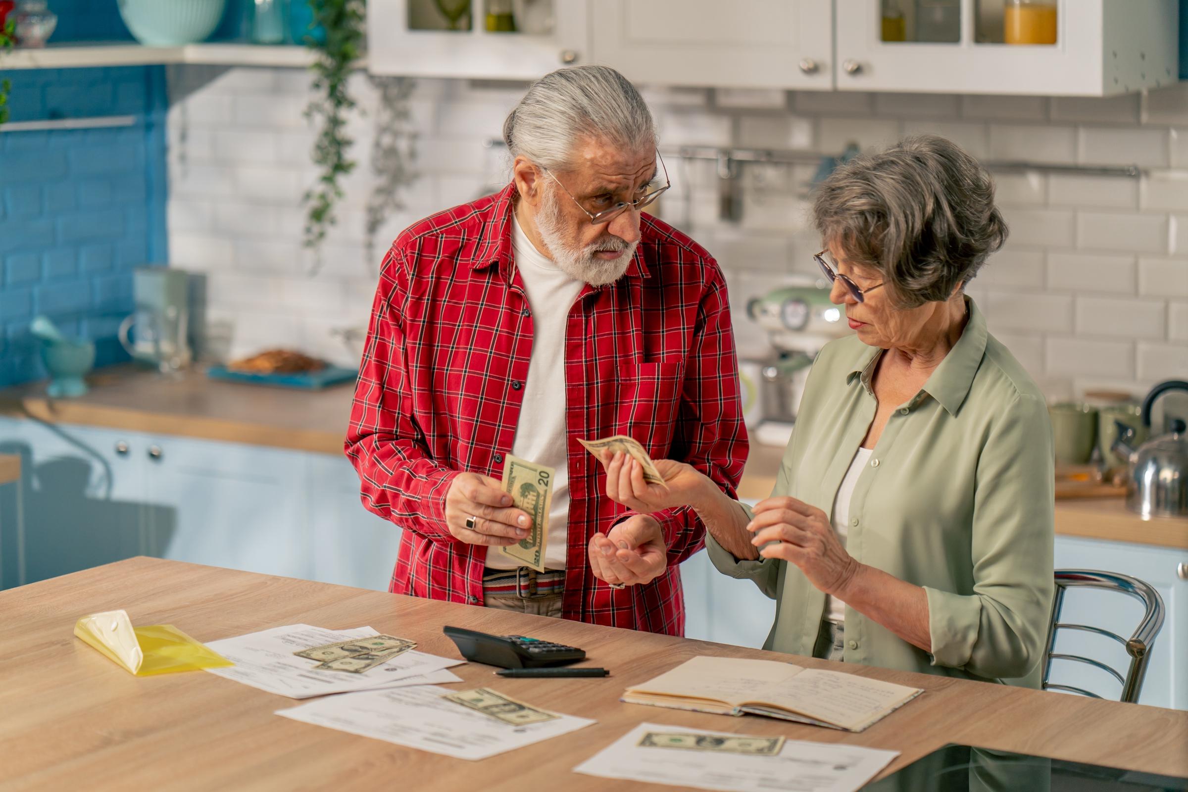 A senior couple managing expenses | Source: Shutterstock