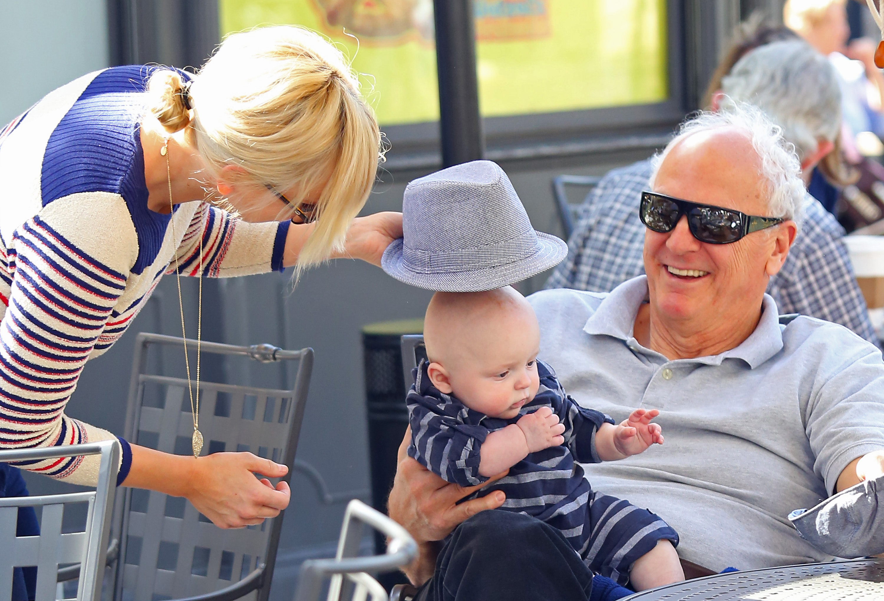 Anna Faris and her father, Jack Faris, share a lighthearted moment with baby Jack Pratt during a day out at The Grove. The family gathering offered a sweet glimpse of the actress enjoying time with her parents and young son.